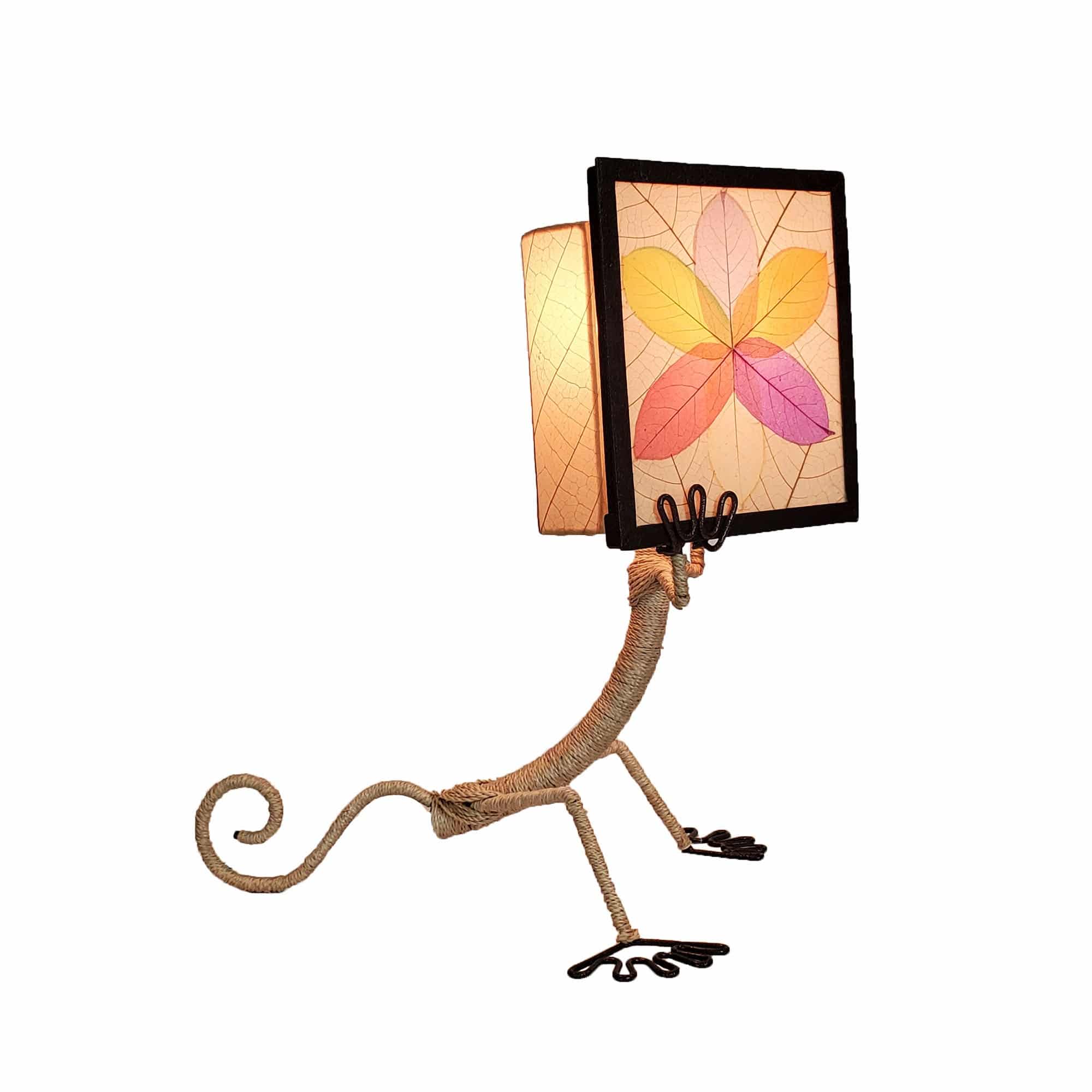 Crafted by the artisans of Eangee Home Design, the Enlightened Gecko Table Lamp in multi color against a clean backdrop, featuring fossilized cocoa leaf shade, guyabano leaf shade, abaca rope accents, wrought iron frame, handcrafted.