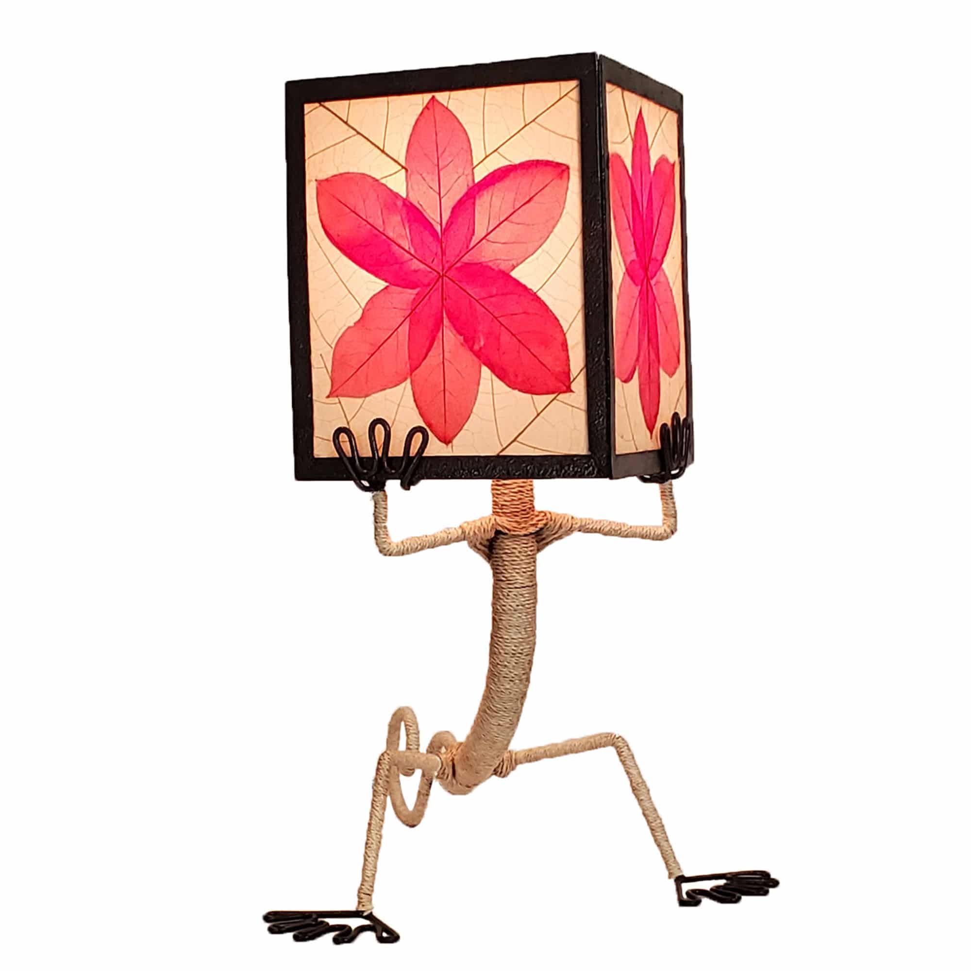 Crafted by the artisans of Eangee Home Design, the Enlightened Gecko Table Lamp in red against a clean backdrop, featuring fossilized cocoa leaf shade, guyabano leaf shade, abaca rope accents, wrought iron frame, handcrafted.