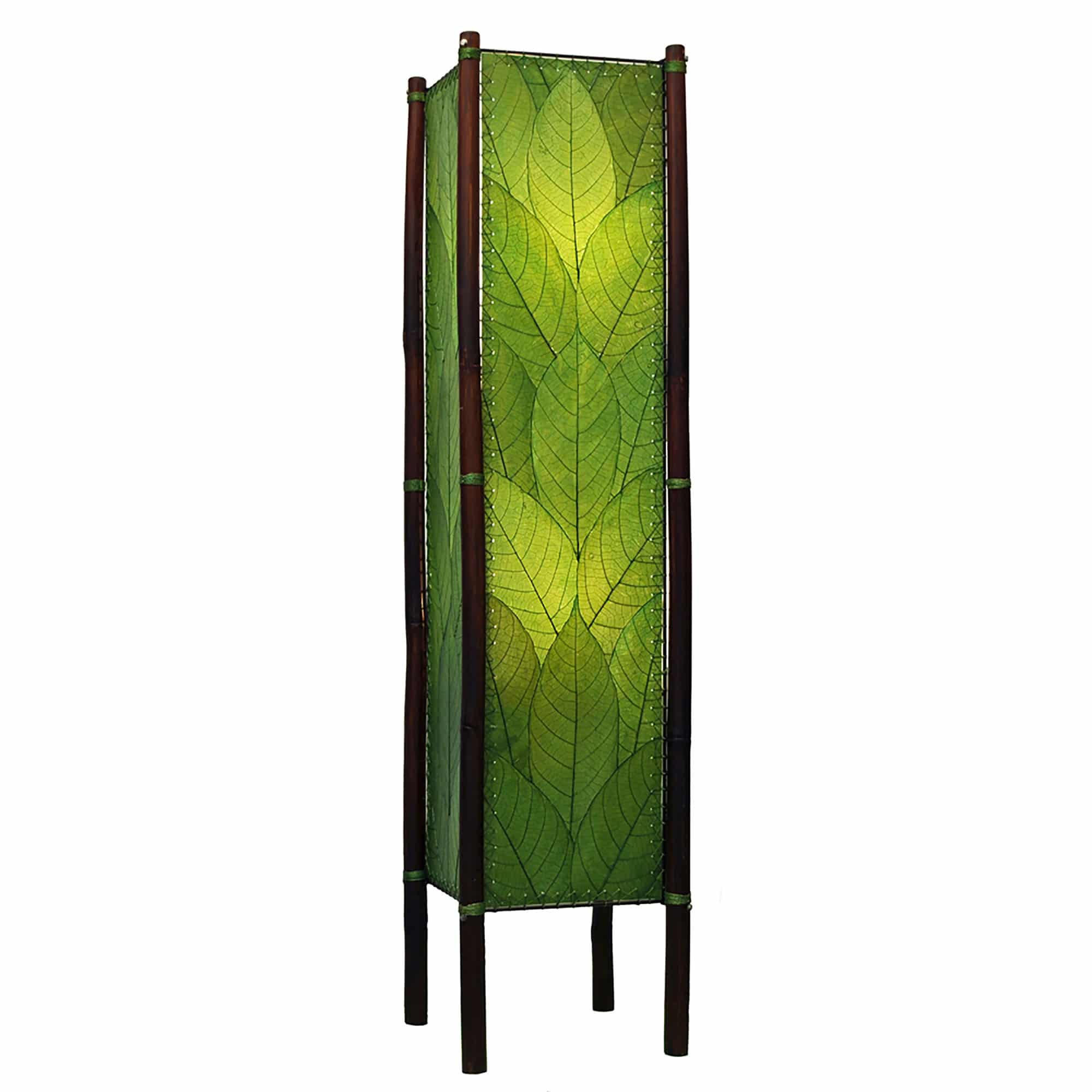 Crafted by the artisans of Eangee Home Design, the Fortune Large Floor Lamp in green against a clean backdrop, featuring fossilized cocoa leaf shade, abaca rope accents, rattan leg supports, wrought iron frame, handcrafted.