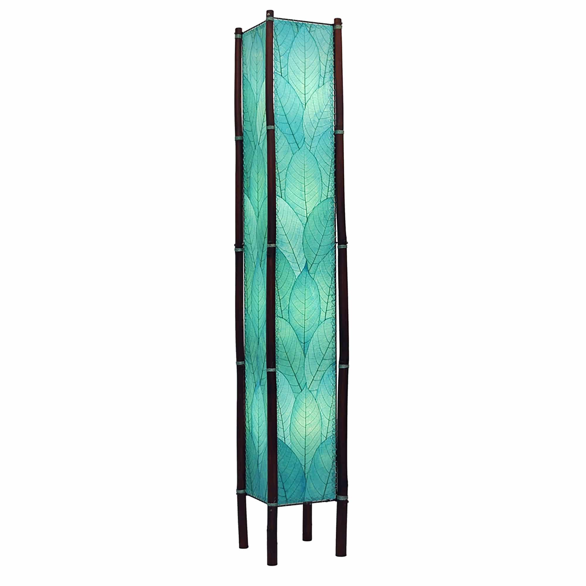 Crafted by the artisans of Eangee Home Design, the Fortune Giant Floor Lamp in sea blue against a clean backdrop, featuring fossilized cocoa leaf shade, abaca rope accents, rattan leg supports, wrought iron frame, eco friendly.