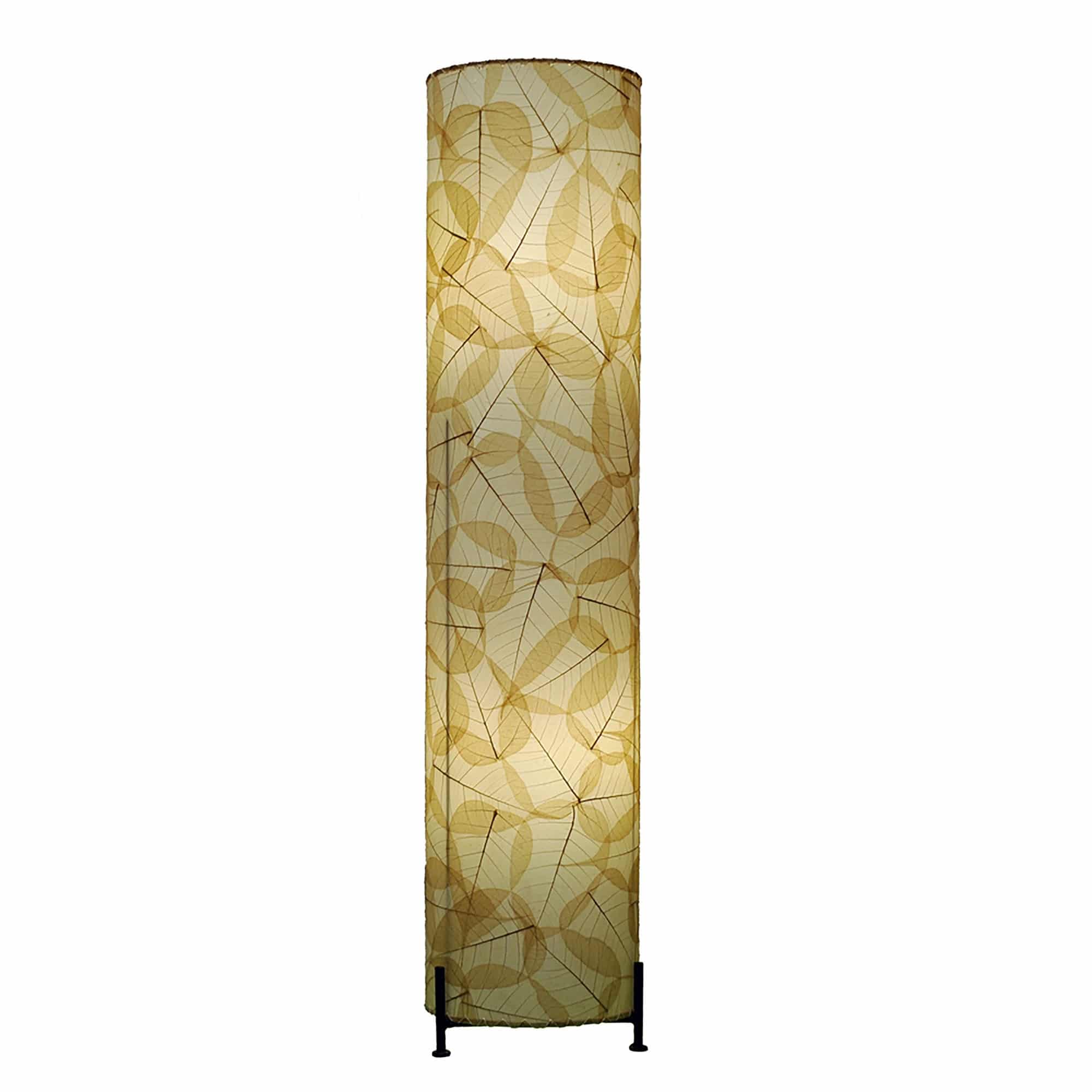 In a softly lit reading nook, crafted by the artisans of Eangee Home Design, the Banyan Large Floor Lamp in natural stands gracefully, featuring fossilized cocoa leaf shade, abaca rope accents, wrought iron frame, eco friendly, handcrafted, adding warmth and character to the space.