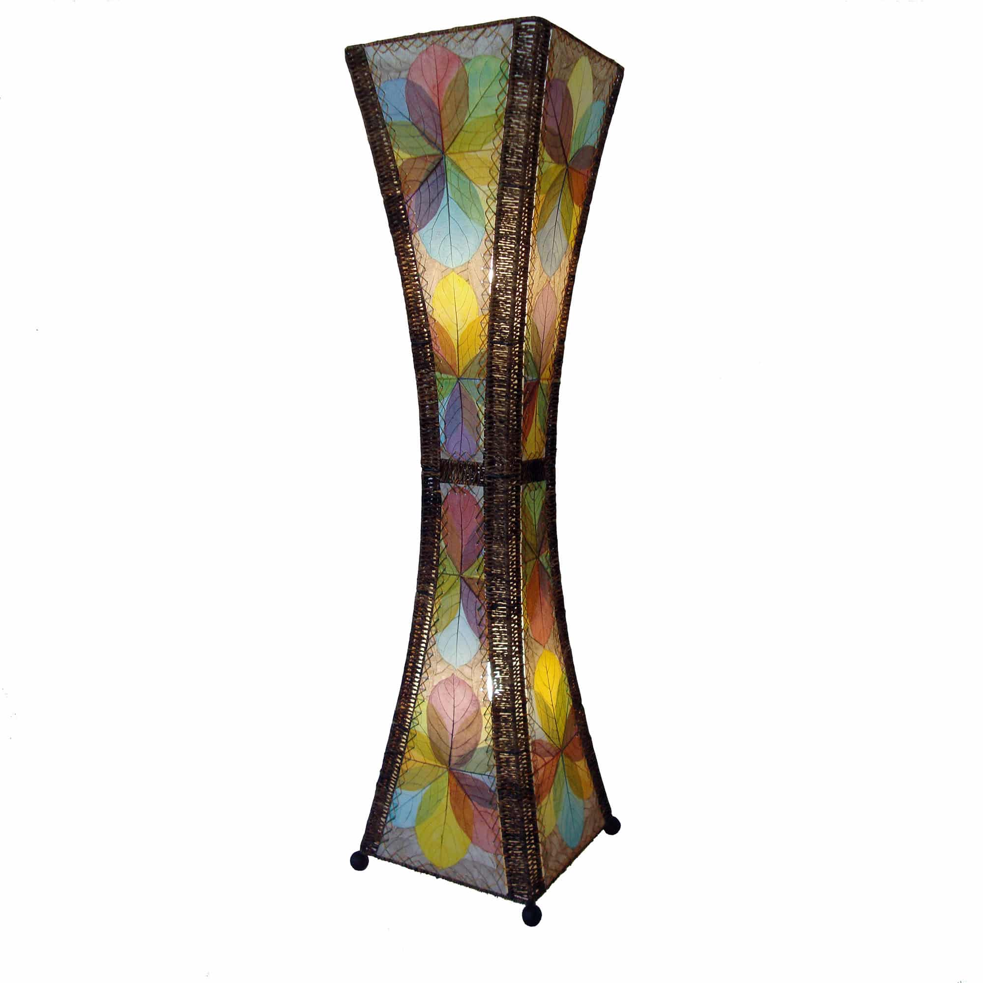 In a softly lit reading nook, crafted by the artisans of Eangee Home Design, the Hourglass Large Floor Lamp in multi color stands gracefully, featuring jackfruit leaf panels, abaca rope accents, fair trade, eco friendly, sustainably sourced, adding warmth and character to the space.
