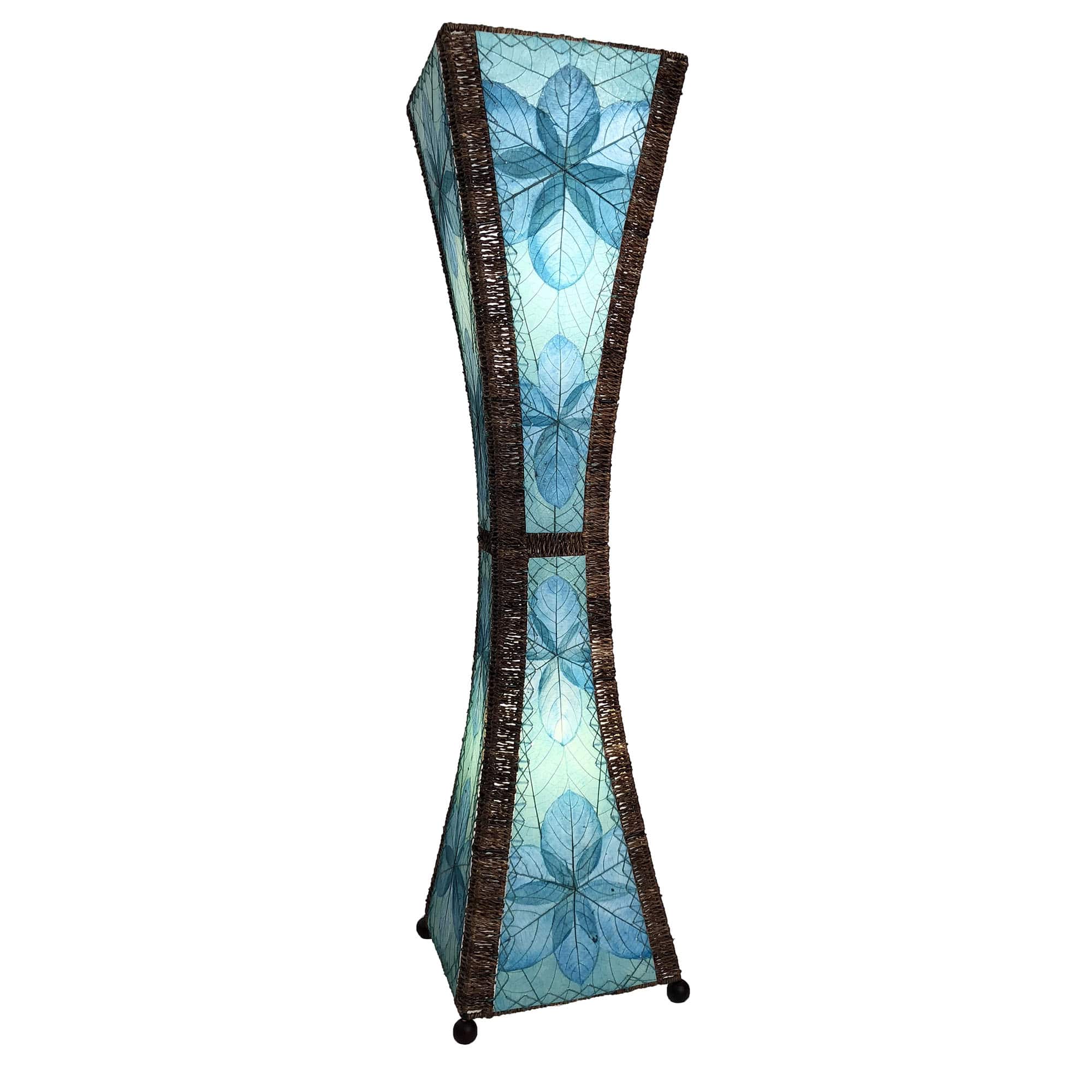 In a sun drenched entryway, crafted by the artisans of Eangee Home Design, the Hourglass Large Floor Lamp in sea blue stands gracefully, featuring jackfruit leaf panels, abaca rope accents, fair trade, eco friendly, sustainably sourced, adding warmth and character to the space.