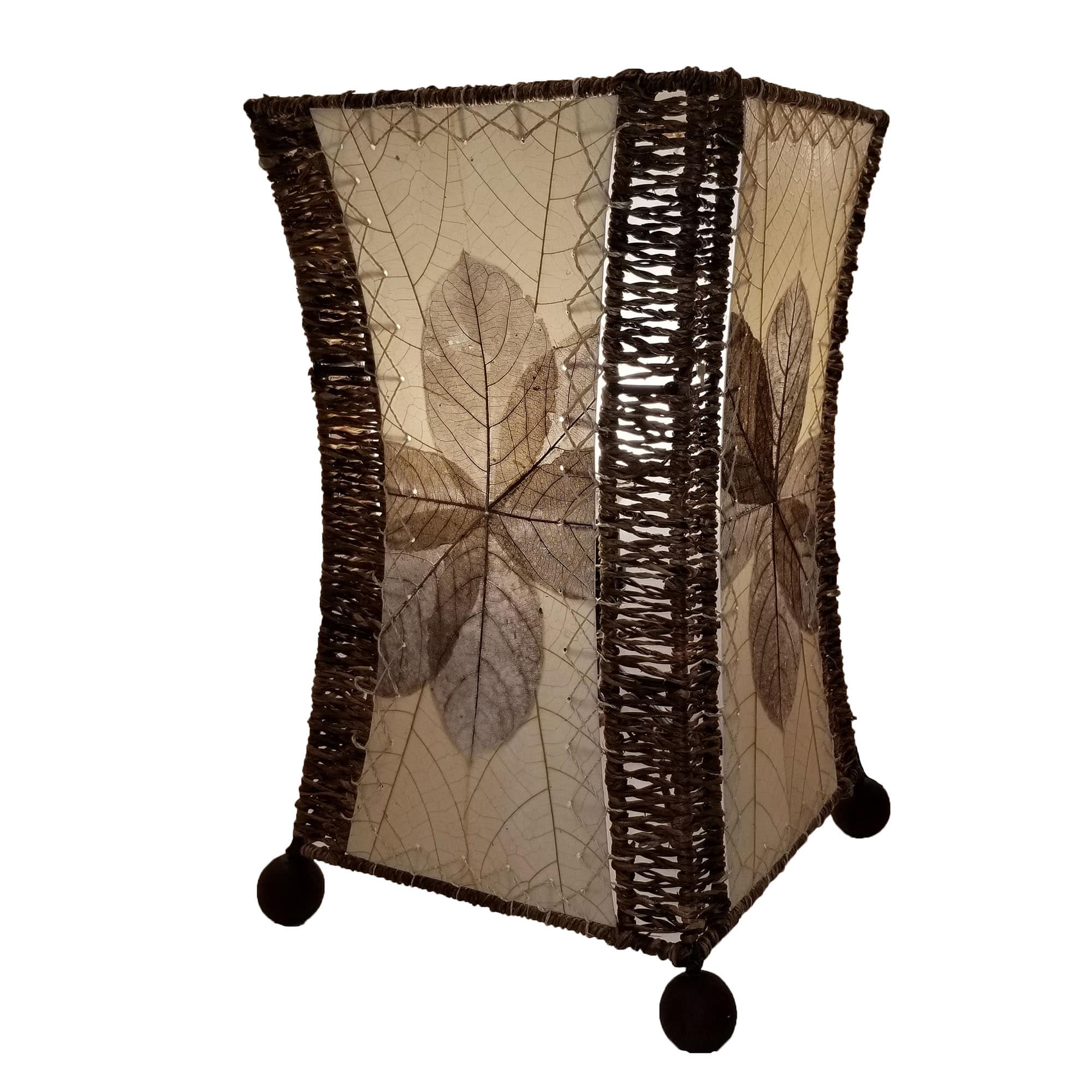 Crafted by the artisans of Eangee Home Design, the Hourglass Table Lamp in natural against a clean backdrop, featuring jackfruit leaf panels, abaca rope accents, wrought iron frame, eco friendly.