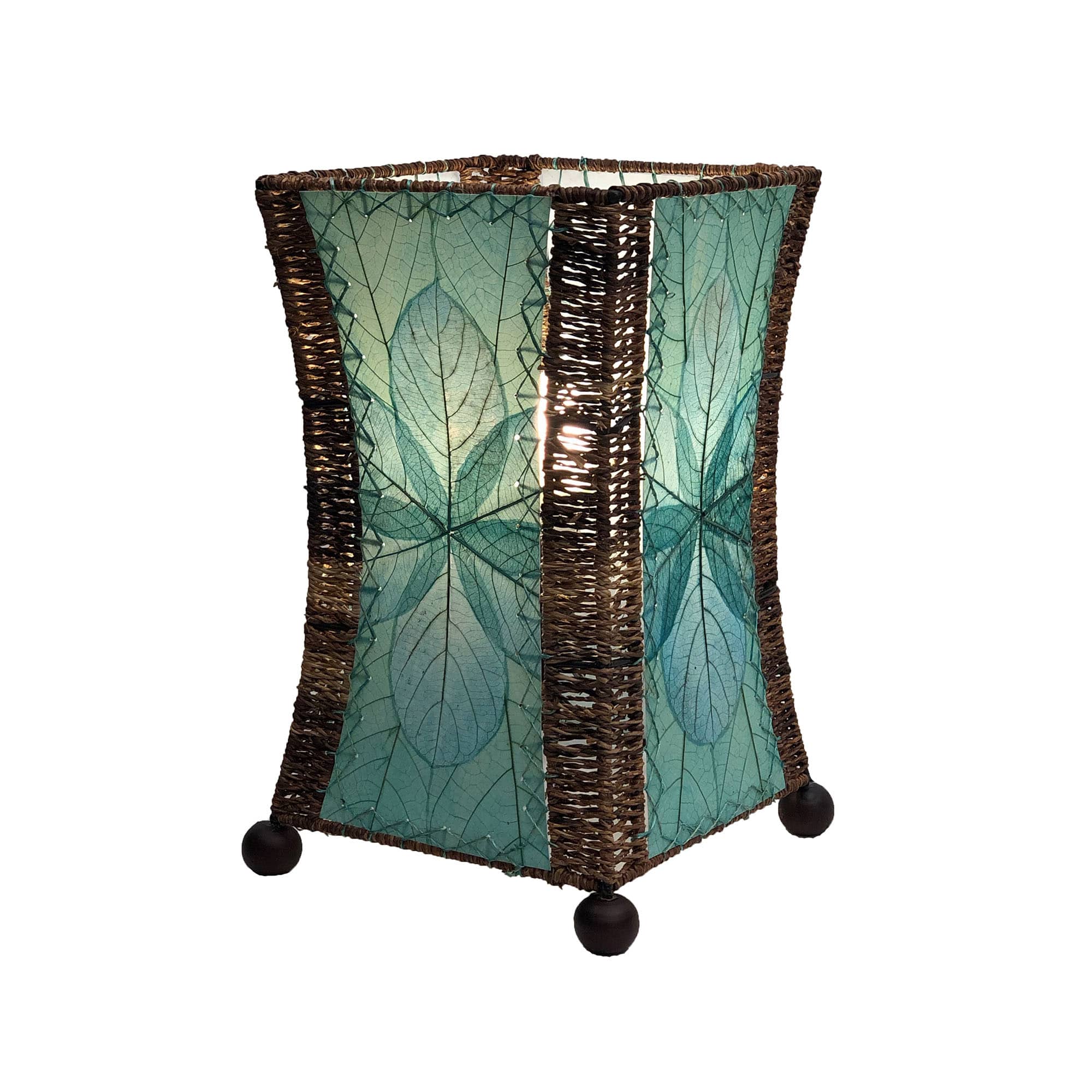 Crafted by the artisans of Eangee Home Design, the Hourglass Table Lamp in sea blue against a clean backdrop, featuring jackfruit leaf panels, abaca rope accents, wrought iron frame, eco friendly.