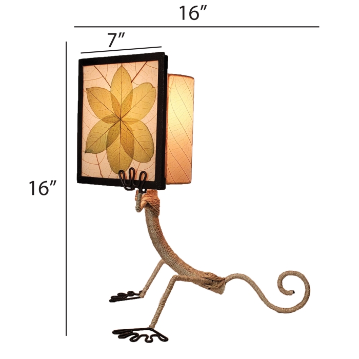 Crafted by the artisans of Eangee Home Design, the Enlightened Gecko Table Lamp in green against a clean backdrop, featuring fossilized cocoa leaf shade, guyabano leaf shade, abaca rope accents, wrought iron frame, handcrafted.