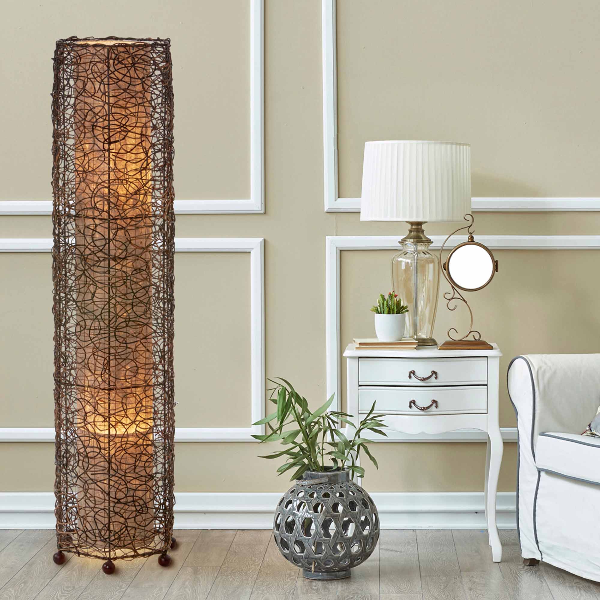 In a coastal inspired living room, crafted by the artisans of Eangee Home Design, the Nito Large Floor Lamp in natural stands gracefully, featuring recycled paper shade, eco friendly, recycled materials, adding warmth and character to the space.