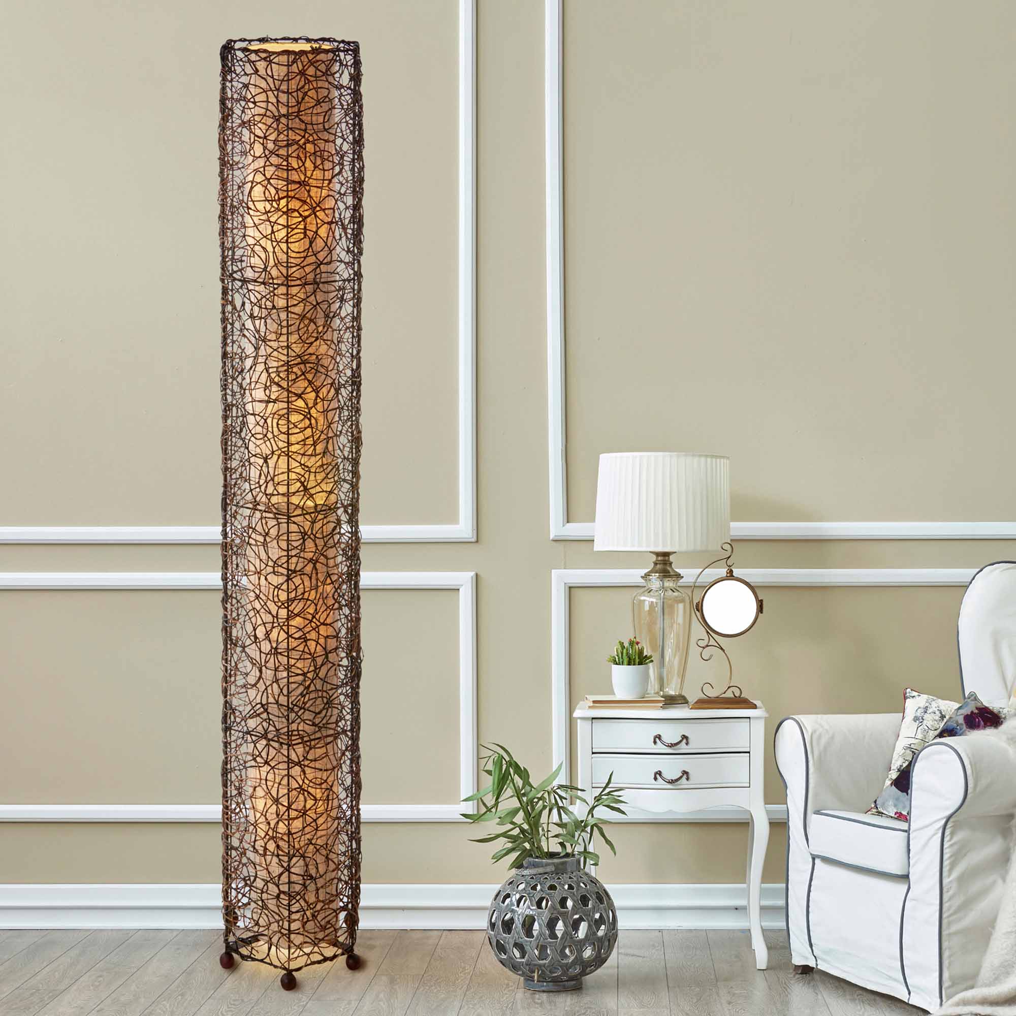 In a sun drenched entryway, crafted by the artisans of Eangee Home Design, the Nito Giant Floor Lamp in natural stands gracefully, featuring recycled paper shade, eco friendly, sustainably sourced, recycled materials, adding warmth and character to the space.