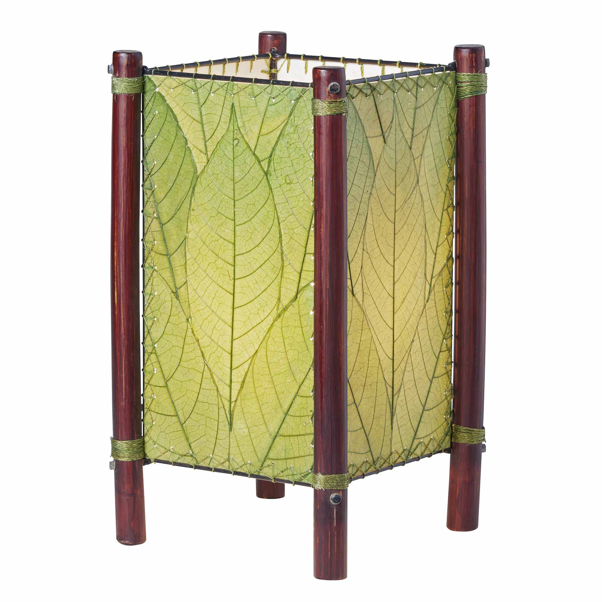 Crafted by the artisans of Eangee Home Design, the Fortune Table Lamp in green against a clean backdrop, featuring fossilized cocoa leaf shade, abaca rope accents, rattan leg supports.