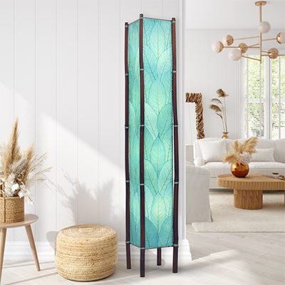 In a quiet bedside corner, crafted by the artisans of Eangee Home Design, the Fortune Giant Floor Lamp in sea blue stands gracefully, featuring fossilized cocoa leaf shade, abaca rope accents, rattan leg supports, wrought iron frame, eco friendly, adding warmth and character to the space.