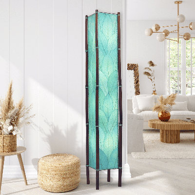 In a quiet bedside corner, crafted by the artisans of Eangee Home Design, the Fortune Giant Floor Lamp in sea blue stands gracefully, featuring fossilized cocoa leaf shade, abaca rope accents, rattan leg supports, wrought iron frame, eco friendly, adding warmth and character to the space.