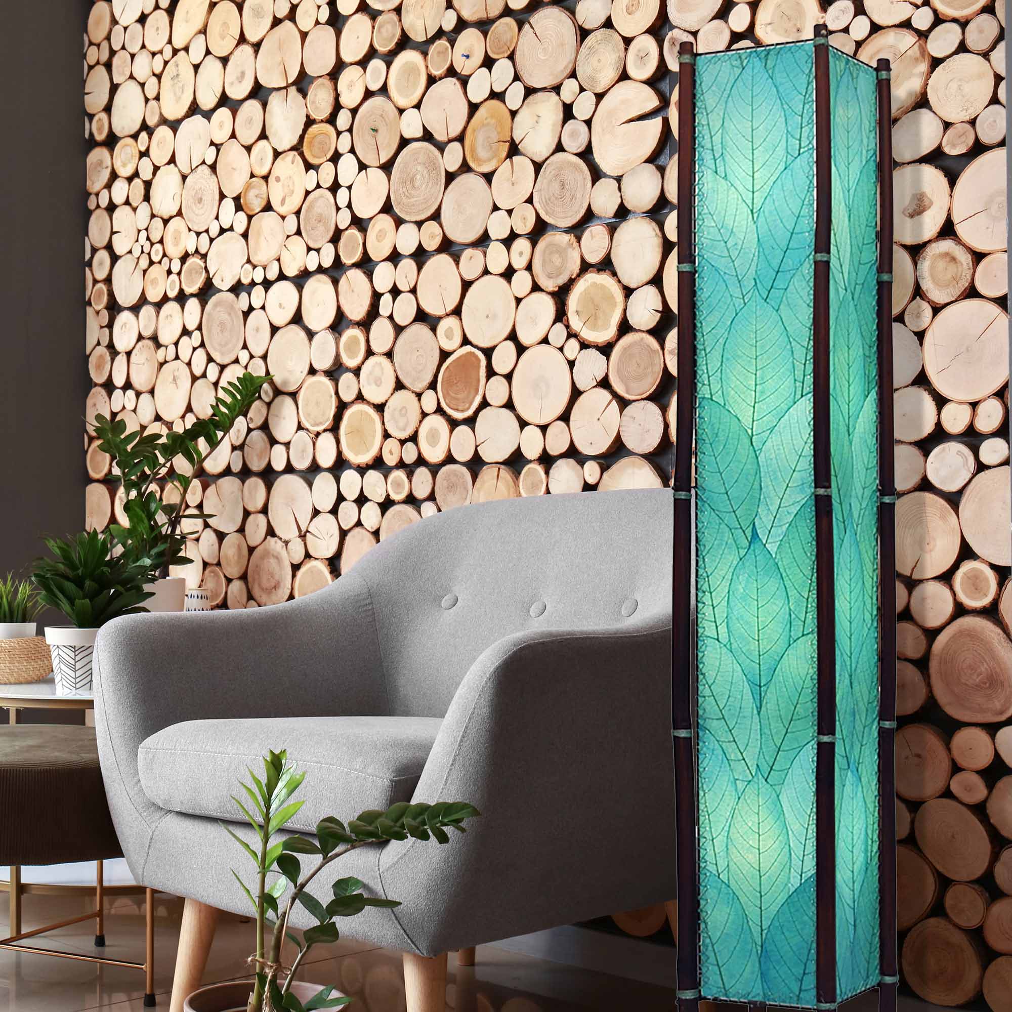 In a softly lit reading nook, crafted by the artisans of Eangee Home Design, the Fortune Giant Floor Lamp in sea blue stands gracefully, featuring fossilized cocoa leaf shade, abaca rope accents, rattan leg supports, wrought iron frame, eco friendly, adding warmth and character to the space.