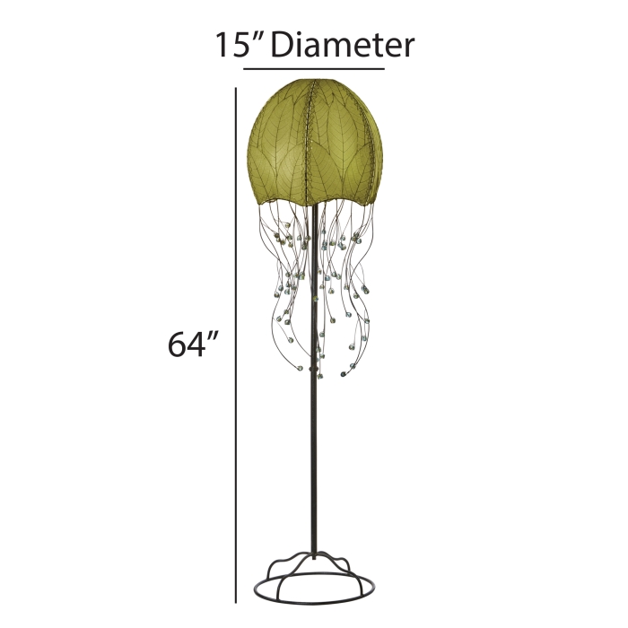 In a reading nook with a linen armchair, the Jellyfish Large Floor crafted by the artisans of Eangee Home Design Lamp in green finish by Eangee Home Design stands tall, its fossilized cocoa leaf panels, powder coated wrought iron frame, wrought iron frame, and hand placed natural leaves casting a warm glow that there's something hypnotic about it this lamp moves you before it ever moves.
