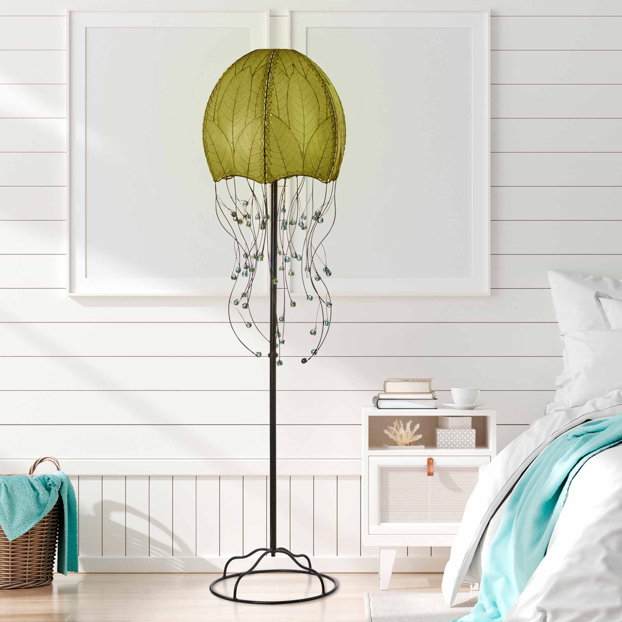 Crafted by the artisans of Eangee Home Design, the Jellyfish Large Floor Lamp in green against a clean backdrop, featuring fossilized cocoa leaf shade, wrought iron frame, eco friendly.