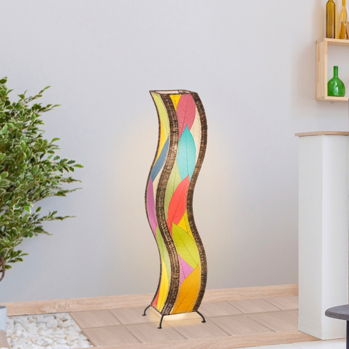 In a coastal inspired living room, crafted by the artisans of Eangee Home Design, the Wave Large Floor Lamp in multi color stands gracefully, featuring fossilized cocoa leaf shade, abaca rope accents, handcrafted, adding warmth and character to the space.