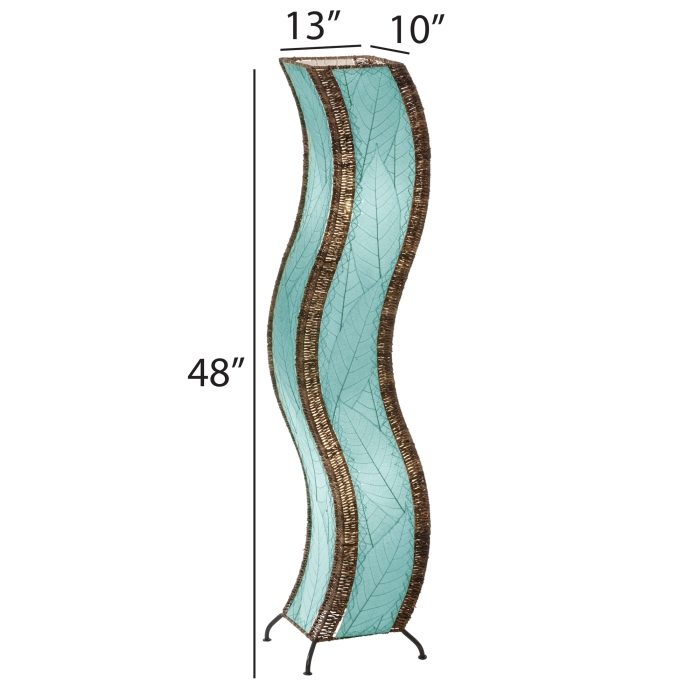 The Eangee Home Design Wave Large Floor Lamp Sea Blue (item #457 l sb), with brown accents, stands on a wooden platform in a modern room beside a green plant and minimalist shelves, adding soothing motion and calm to the space.