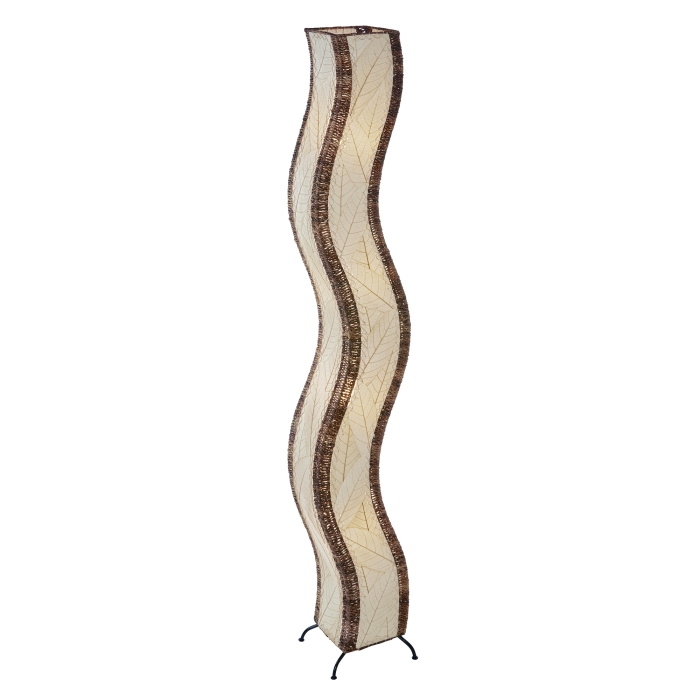In a modern living room, the Wave Giant Floor crafted by the artisans of Eangee Home Design Lamp in natural finish by Eangee Home Design stands tall, its fossilized cocoa leaf panels, abaca twine accents, and hand placed natural leaves casting a warm glow that some designs don't just decorate a space they shape the way it moves.