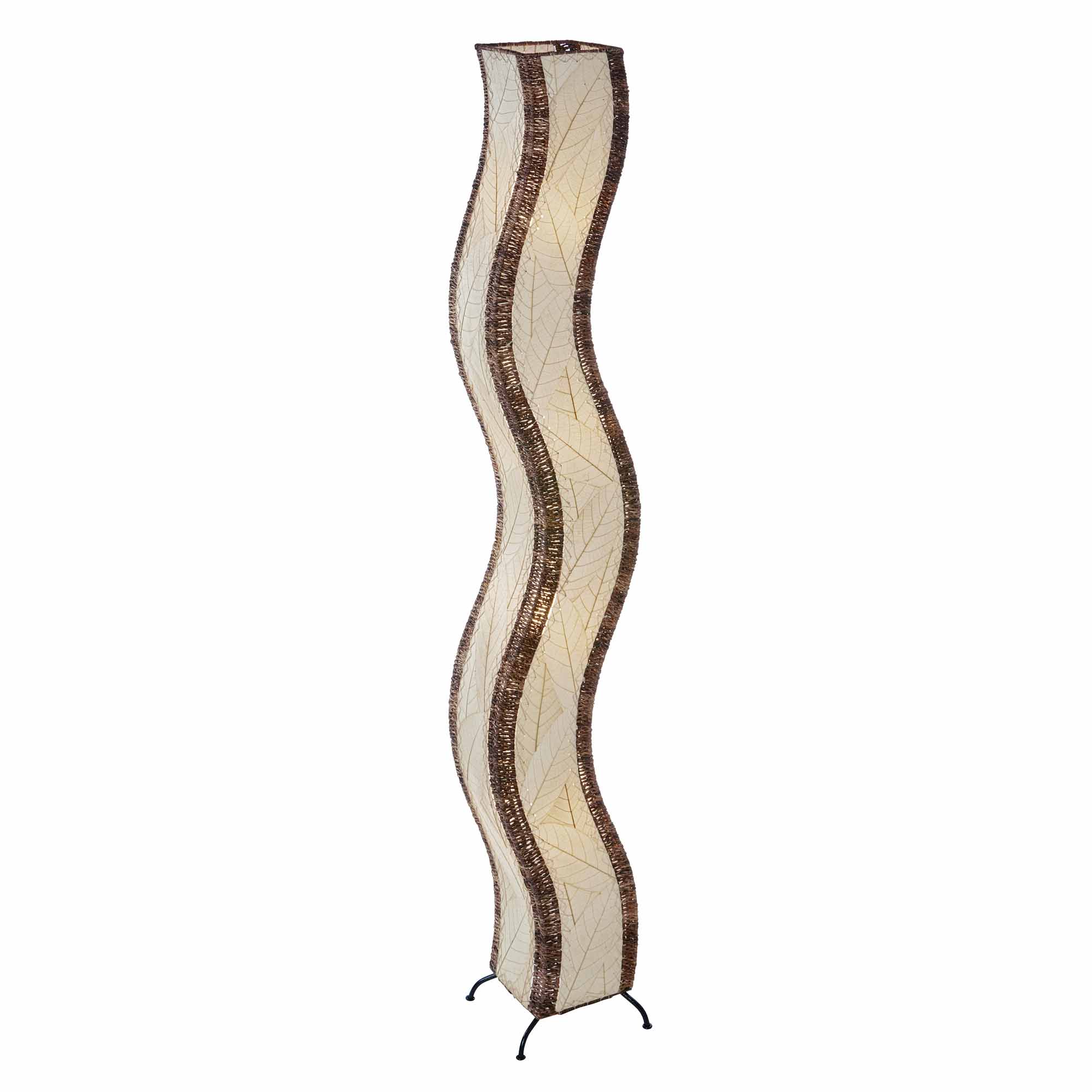 In a modern living room, the Wave Giant Floor crafted by the artisans of Eangee Home Design Lamp in natural finish by Eangee Home Design stands tall, its fossilized cocoa leaf panels, abaca twine accents, and hand placed natural leaves casting a warm glow that some designs don't just decorate a space they shape the way it moves.