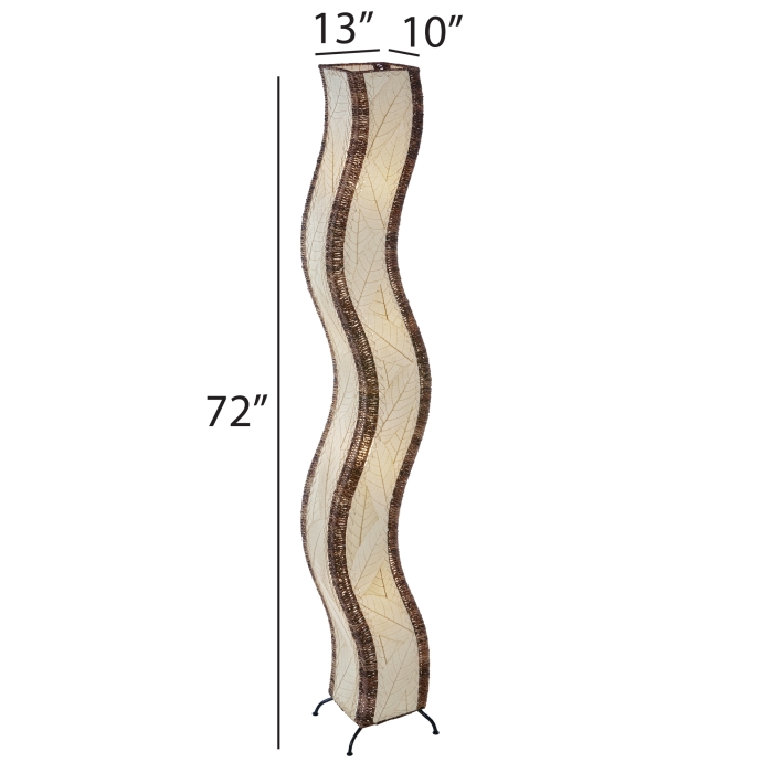 The Eangee Home Design Wave Giant Floor Lamp Natural (Item #457 xl n) features a tall, wavy beige surface with brown abaca rope edges, standing stylishly in a modern living room by plants, shelves of decor, and a gray counter.