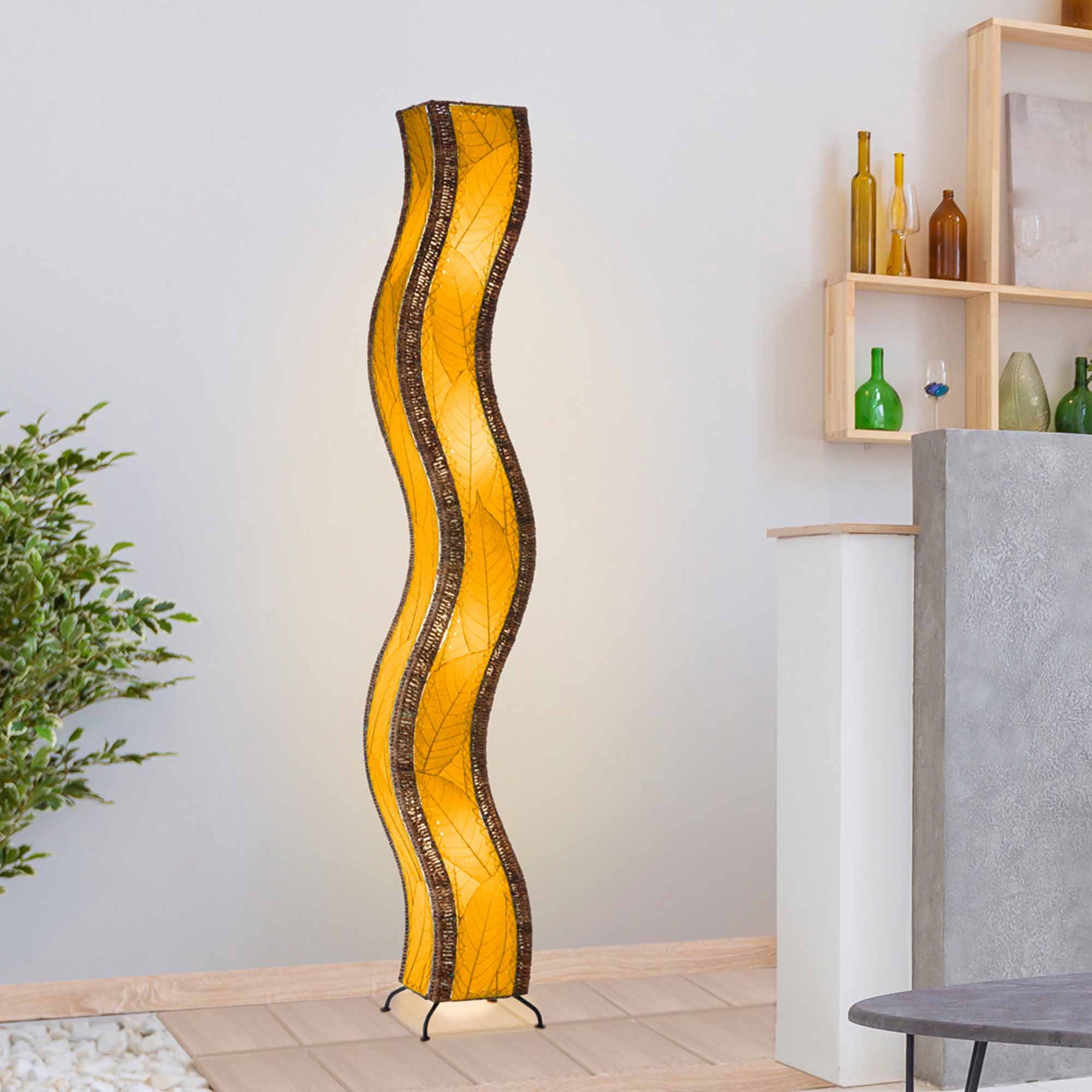 Crafted by the artisans of Eangee Home Design, the Wave Giant Floor Lamp in orange against a clean backdrop, featuring fossilized cocoa leaf shade, abaca rope accents, eco friendly, handcrafted.