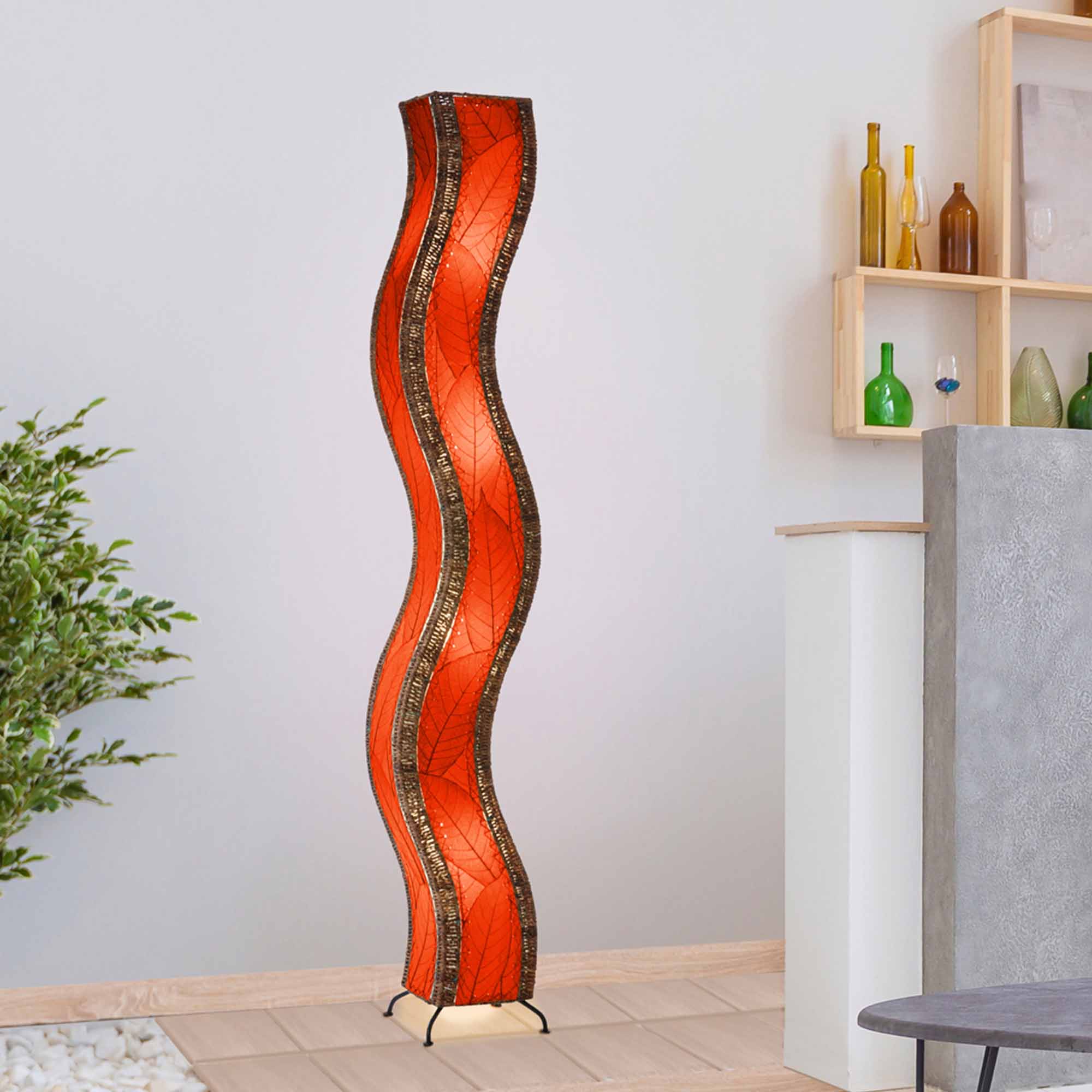 Crafted by the artisans of Eangee Home Design, the Wave Giant Floor Lamp in red against a clean backdrop, featuring fossilized cocoa leaf shade, abaca rope accents, eco friendly, handcrafted.