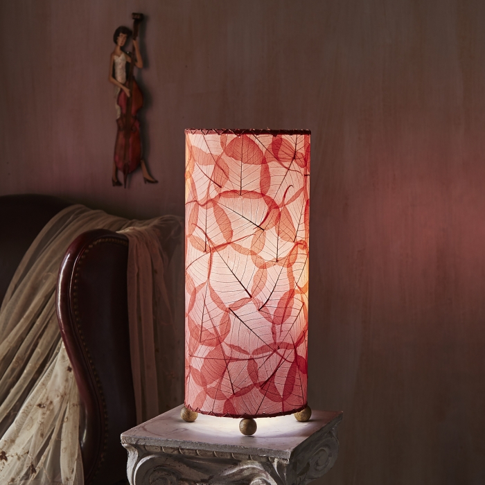 In a modern interior with earth tones, crafted by the artisans of Eangee Home Design, the Banyan Table Lamp in red stands gracefully, featuring wrought iron frame, eco friendly, adding warmth and character to the space.