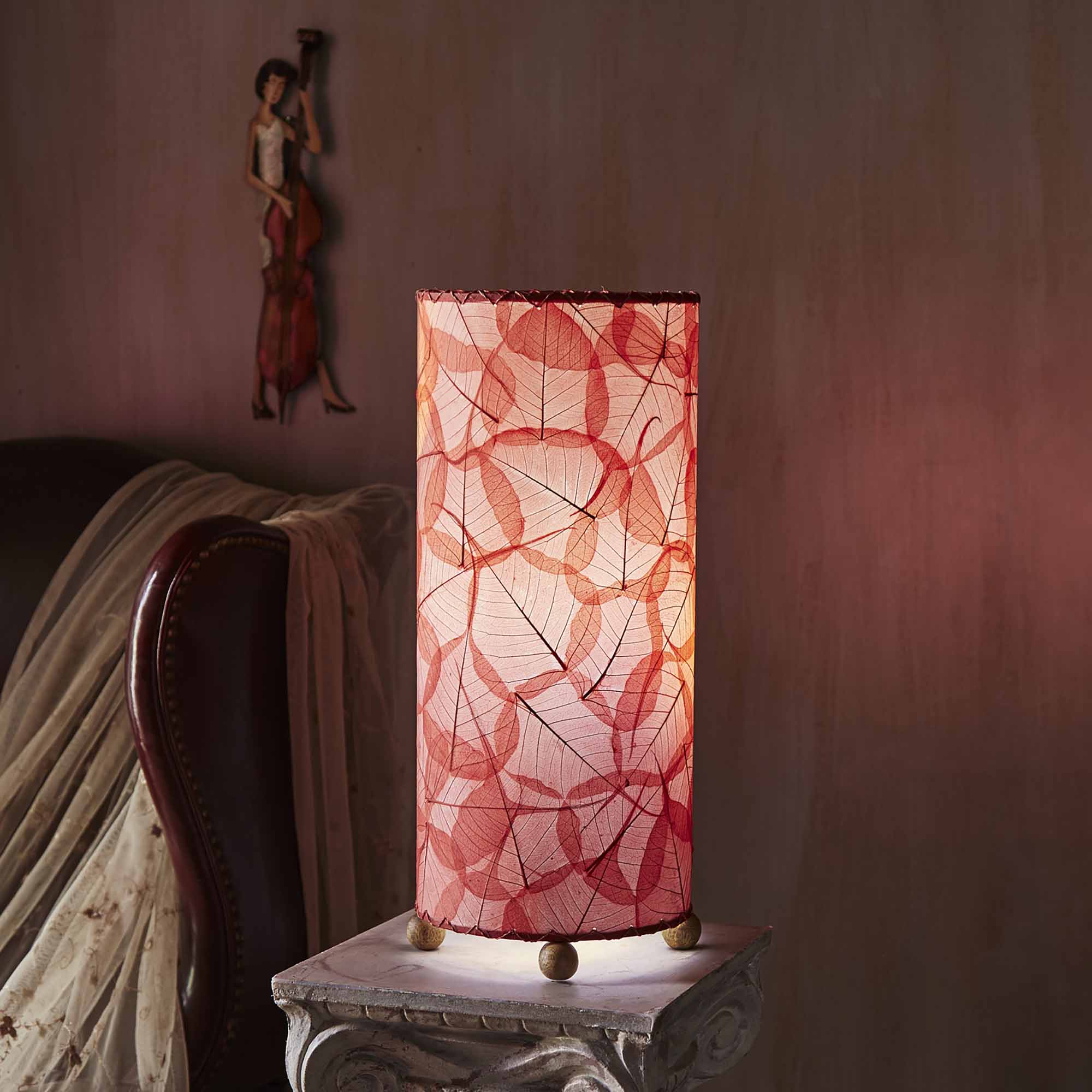 In a modern interior with earth tones, crafted by the artisans of Eangee Home Design, the Banyan Table Lamp in red stands gracefully, featuring wrought iron frame, eco friendly, adding warmth and character to the space.