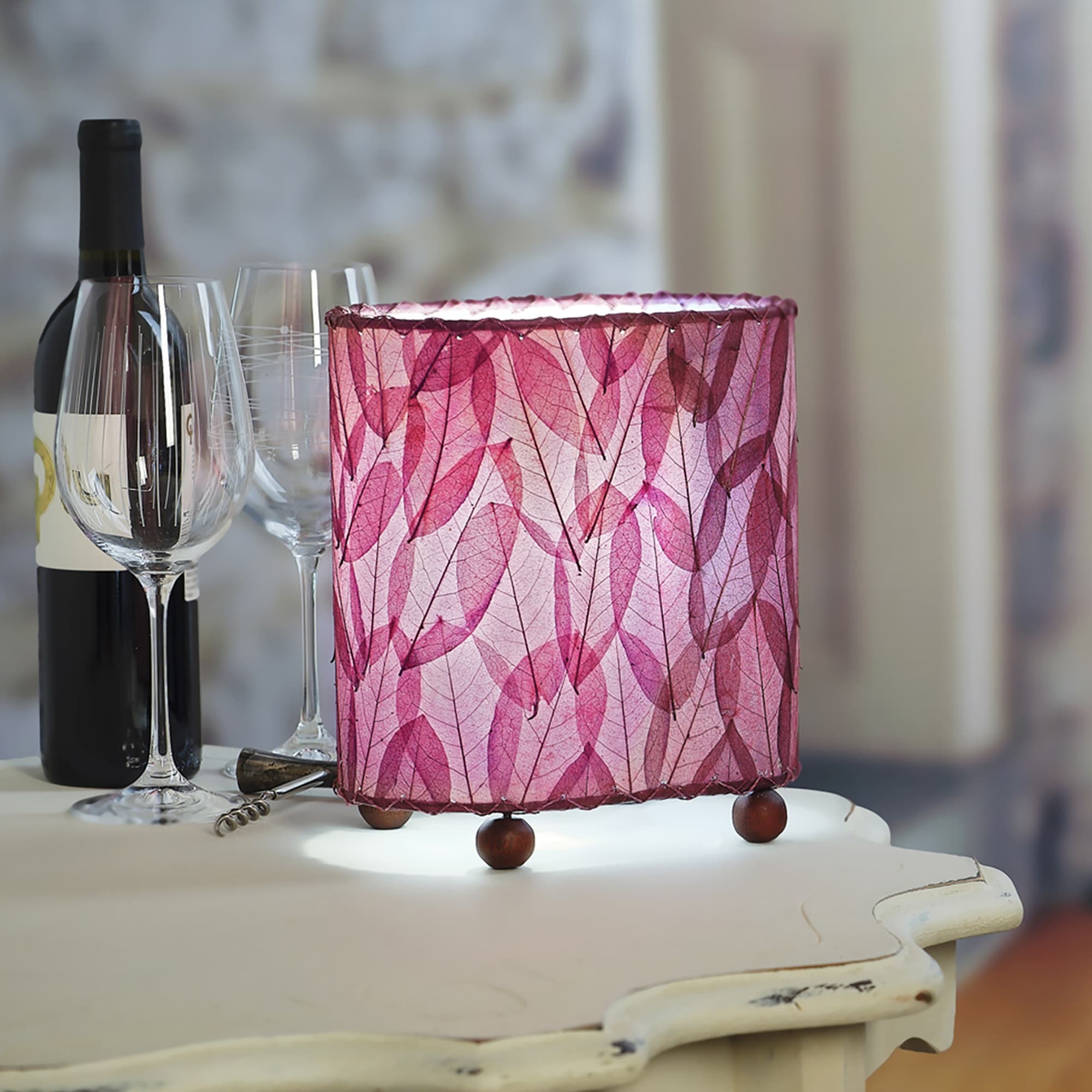 Crafted by the artisans of Eangee Home Design, the Mini Guyabano Table Lamp in purple against a clean backdrop, featuring fossilized cocoa leaf shade, guyabano leaf shade, wrought iron frame.