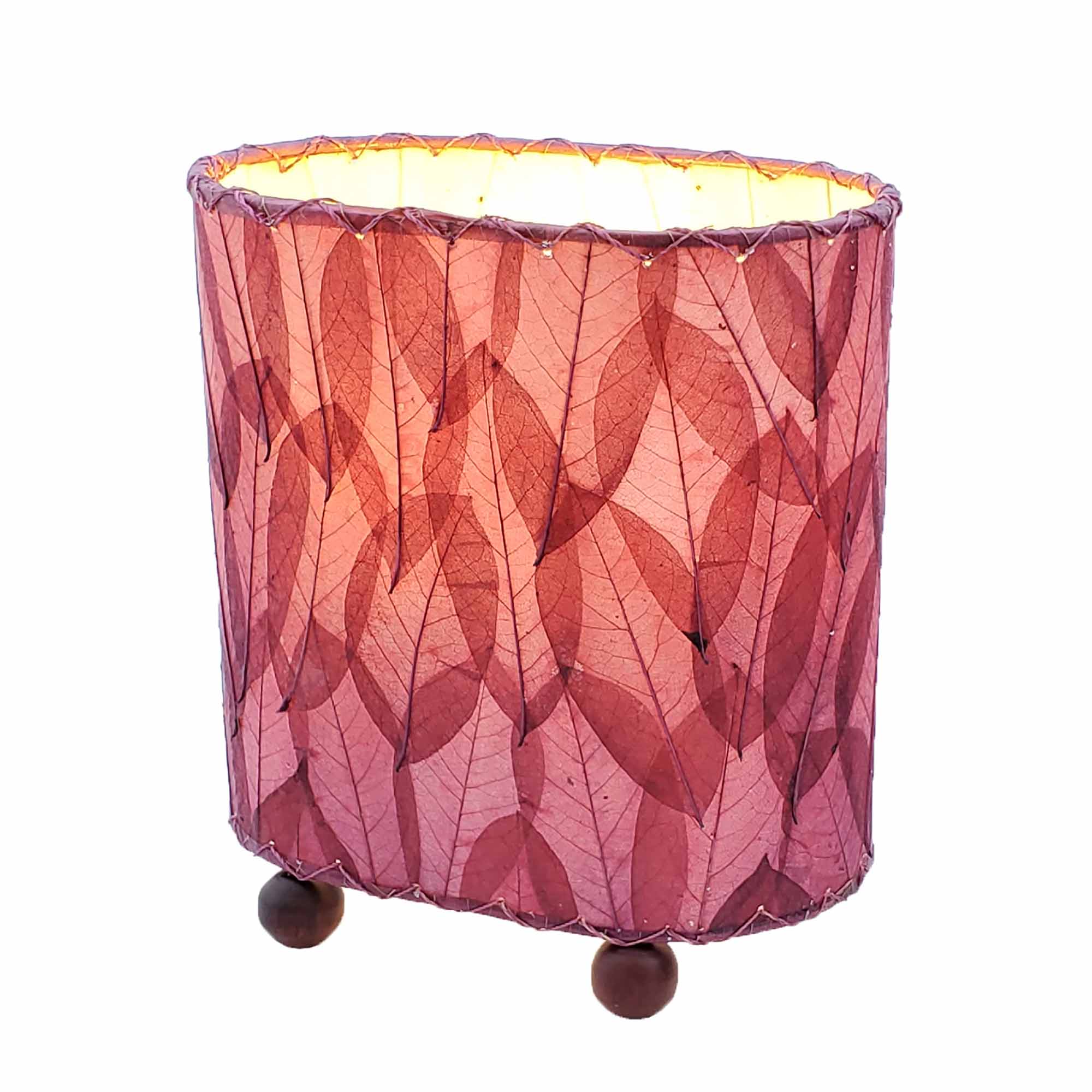 Crafted by the artisans of Eangee Home Design, the Mini Guyabano Table Lamp in purple against a clean backdrop, featuring fossilized cocoa leaf shade, guyabano leaf shade, wrought iron frame.