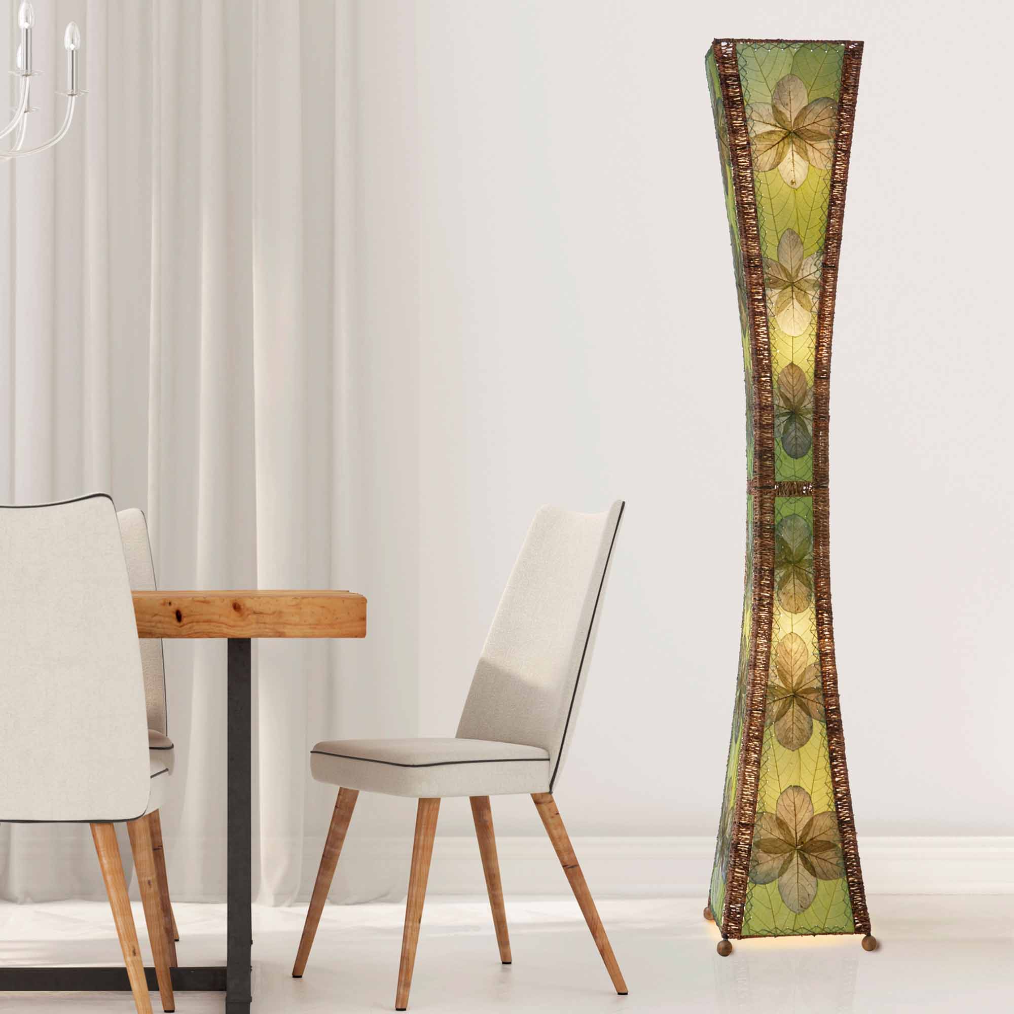 Crafted by the artisans of Eangee Home Design, the Hourglass Giant Floor Lamp in green against a clean backdrop, featuring jackfruit leaf panels, abaca rope accents, wrought iron frame, eco friendly, handcrafted.