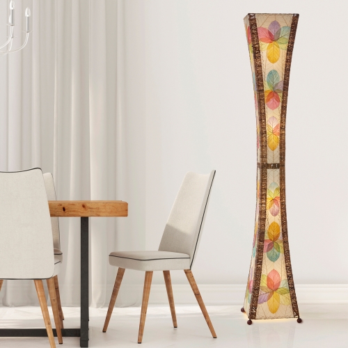 In a softly lit reading nook, crafted by the artisans of Eangee Home Design, the Hourglass Giant Floor Lamp in multi color stands gracefully, featuring jackfruit leaf panels, abaca rope accents, wrought iron frame, eco friendly, handcrafted, adding warmth and character to the space.