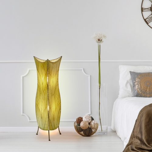 In a coastal inspired living room, crafted by the artisans of Eangee Home Design, the Flowerbud Large Floor Lamp in green stands gracefully, featuring fossilized cocoa leaf shade, adding warmth and character to the space.