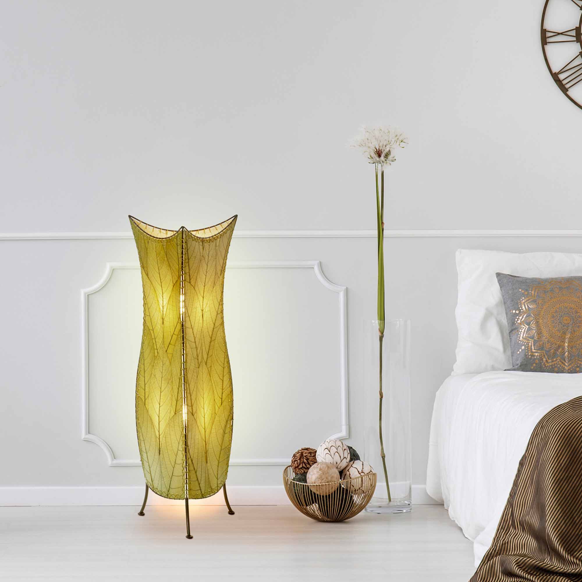 In a coastal inspired living room, crafted by the artisans of Eangee Home Design, the Flowerbud Large Floor Lamp in green stands gracefully, featuring fossilized cocoa leaf shade, adding warmth and character to the space.