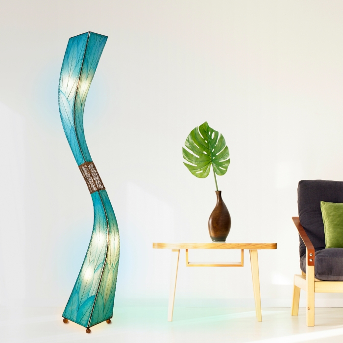 In a minimalist loft with natural textures, crafted by the artisans of Eangee Home Design, the Flow Giant Floor Lamp in sea blue stands gracefully, featuring fossilized cocoa leaf shade, abaca rope accents, eco friendly, adding warmth and character to the space.