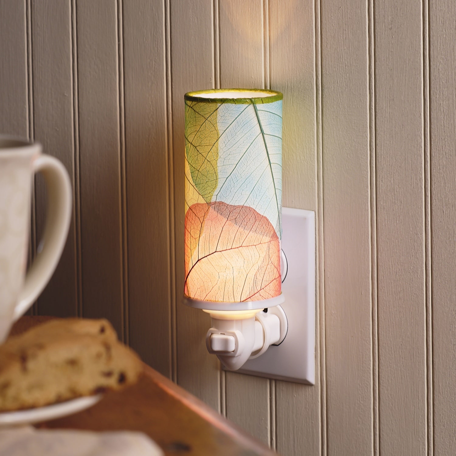 In a coastal inspired living room, crafted by the artisans of Eangee Home Design, the Cylinder Nightlight in multi color stands gracefully, featuring handcrafted detailing, fair trade, eco friendly, adding warmth and character to the space.