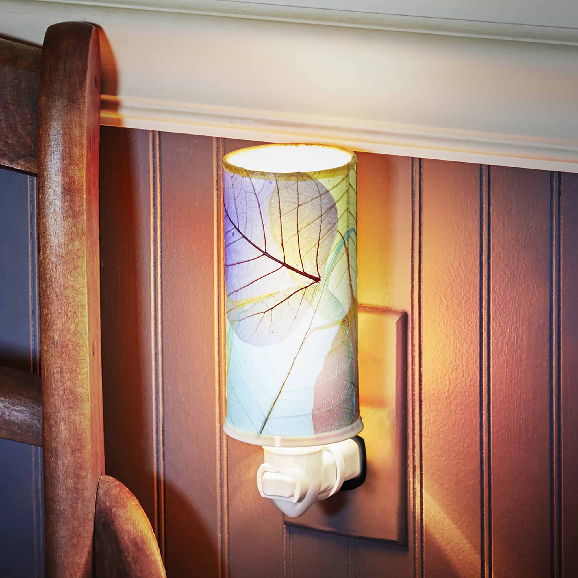 In a coastal inspired living room, crafted by the artisans of Eangee Home Design, the Cylinder Nightlight in multi color stands gracefully, featuring handcrafted detailing, fair trade, eco friendly, adding warmth and character to the space.