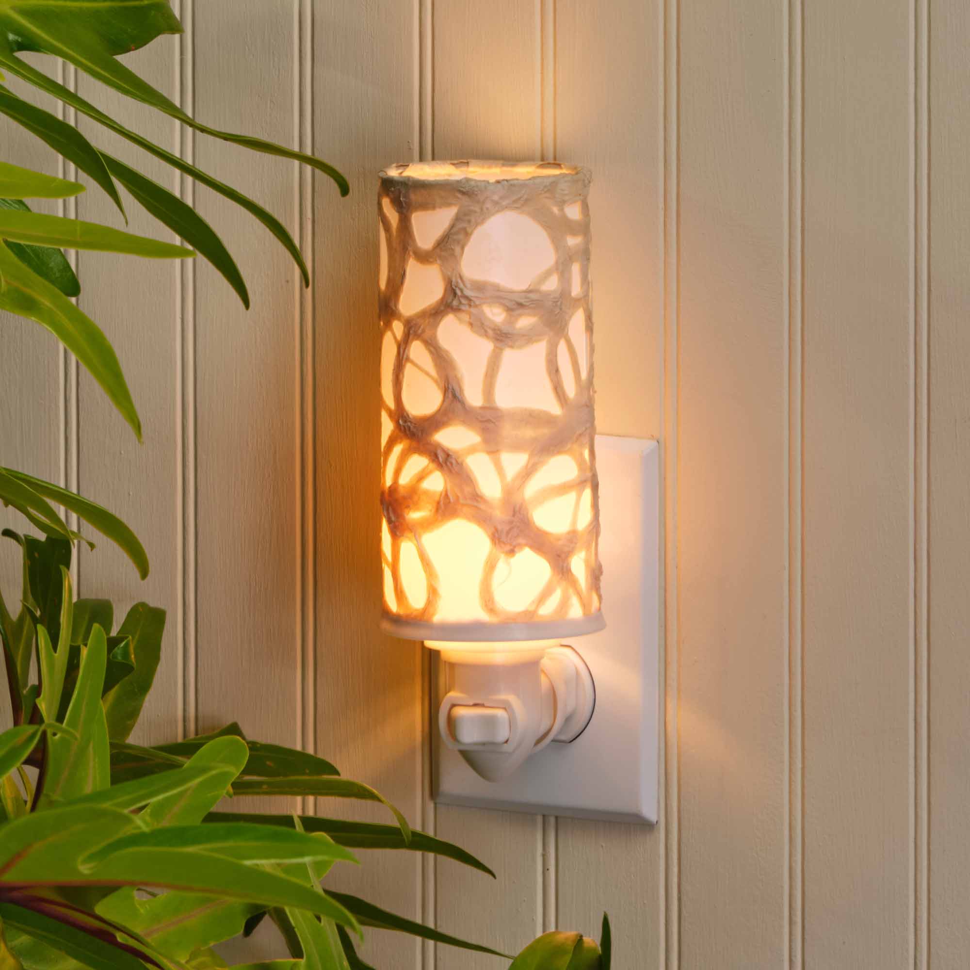 Crafted by the artisans of Eangee Home Design, the Paper Nightlight Swirl in natural against a clean backdrop, featuring recycled paper shade, sustainably sourced, handcrafted, recycled materials.