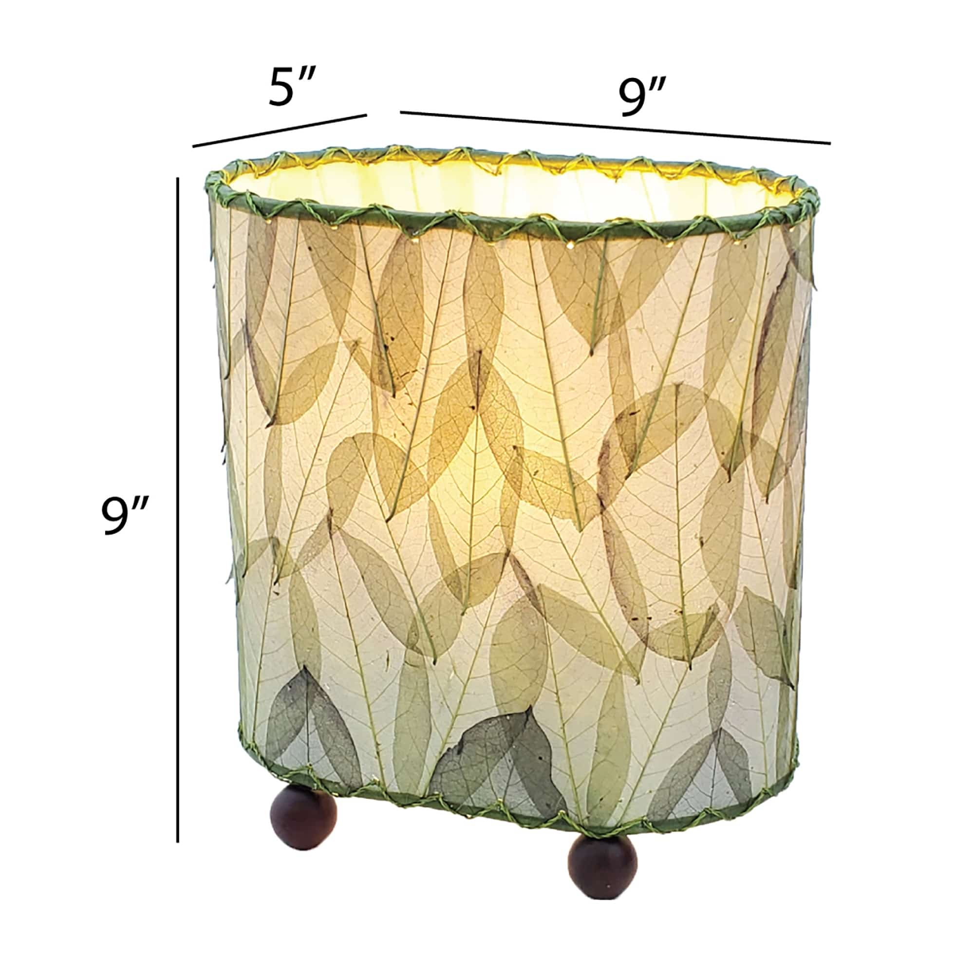 Crafted by the artisans of Eangee Home Design, the Mini Guyabano Table Lamp in green against a clean backdrop, featuring fossilized cocoa leaf shade, guyabano leaf shade, wrought iron frame.