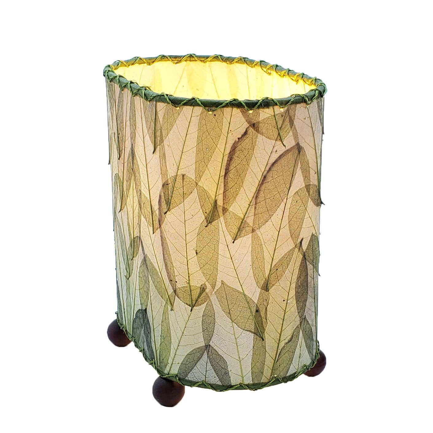 Crafted by the artisans of Eangee Home Design, the Mini Guyabano Table Lamp in green against a clean backdrop, featuring fossilized cocoa leaf shade, guyabano leaf shade, wrought iron frame.