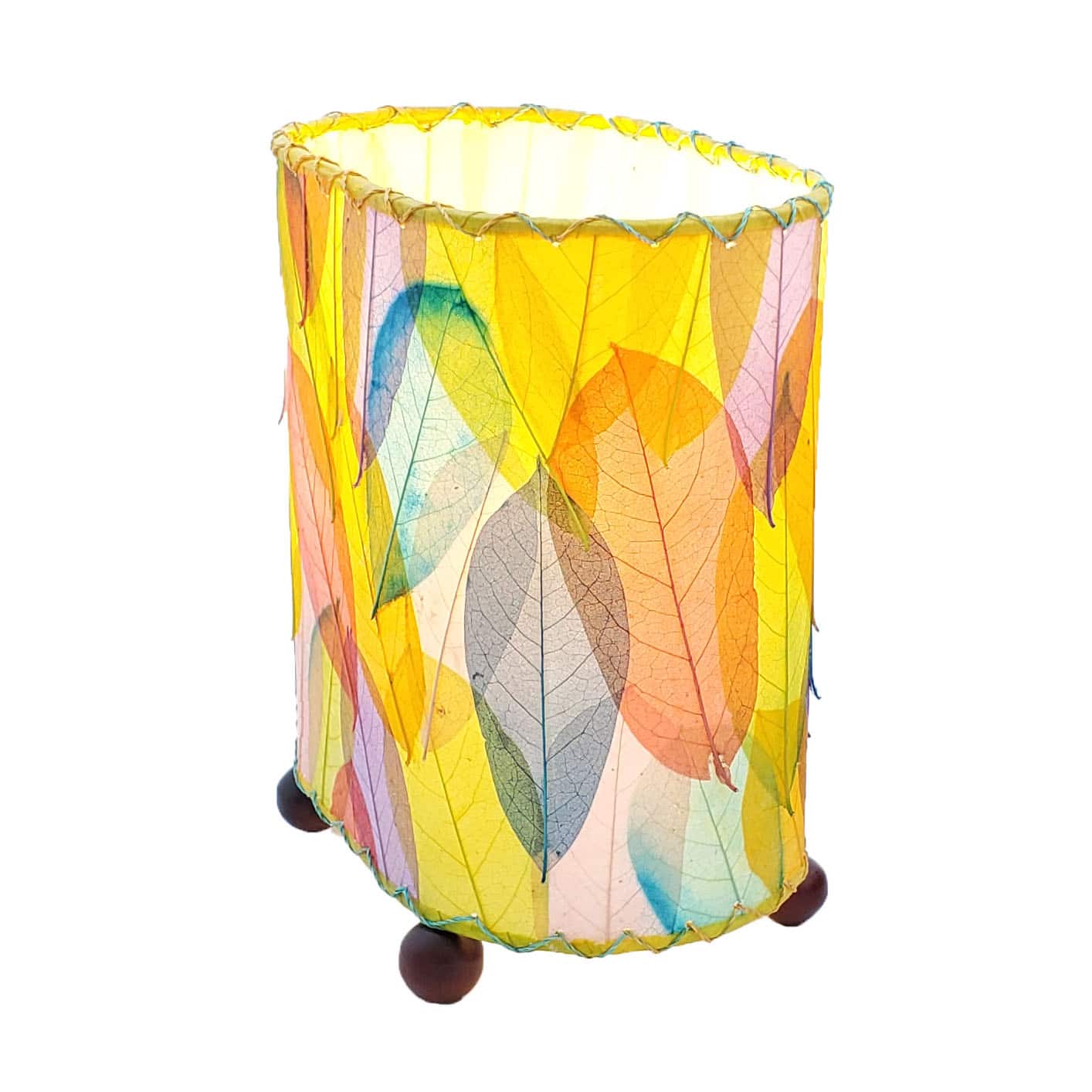 Crafted by the artisans of Eangee Home Design, the Mini Guyabano Table Lamp in multi color against a clean backdrop, featuring fossilized cocoa leaf shade, guyabano leaf shade, wrought iron frame.