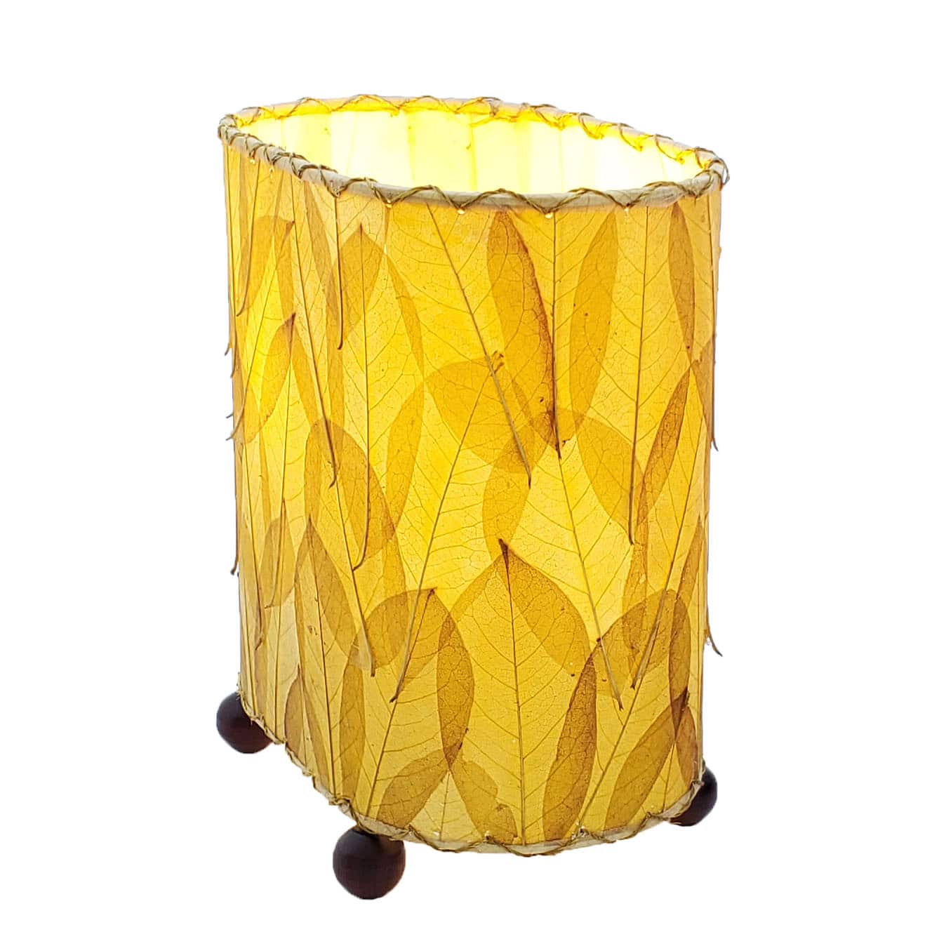 Crafted by the artisans of Eangee Home Design, the Mini Guyabano Table Lamp in natural against a clean backdrop, featuring fossilized cocoa leaf shade, guyabano leaf shade, wrought iron frame.