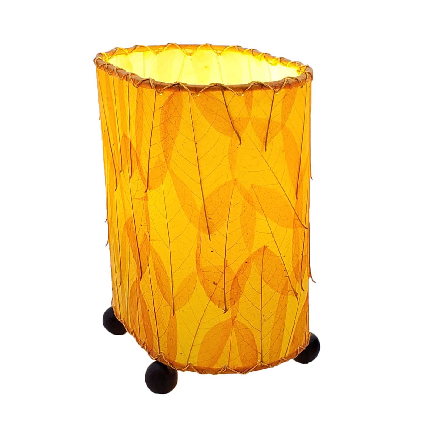 Crafted by the artisans of Eangee Home Design, the Mini Guyabano Table Lamp in orange against a clean backdrop, featuring fossilized cocoa leaf shade, guyabano leaf shade, wrought iron frame.
