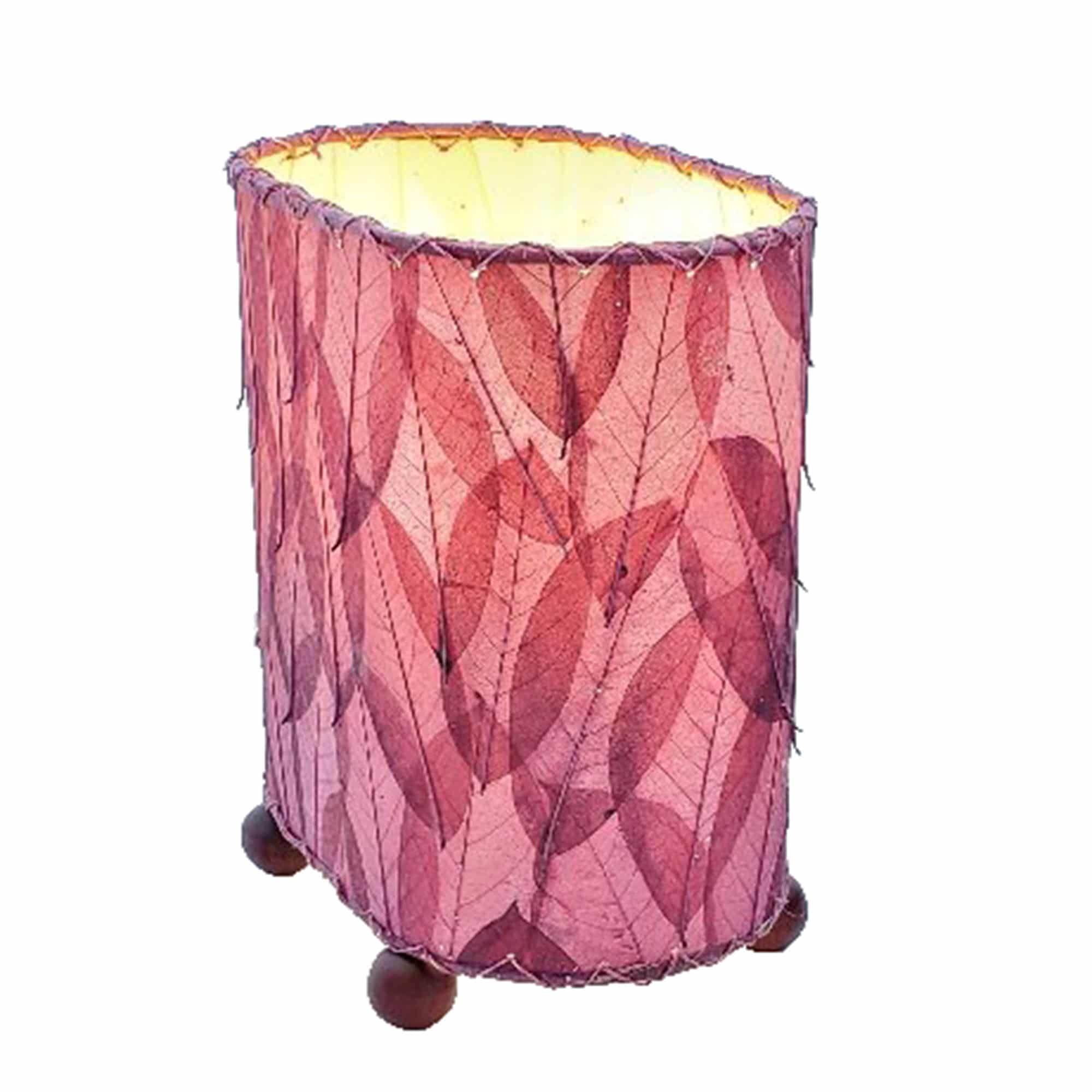 Crafted by the artisans of Eangee Home Design, the Mini Guyabano Table Lamp in purple against a clean backdrop, featuring fossilized cocoa leaf shade, guyabano leaf shade, wrought iron frame.