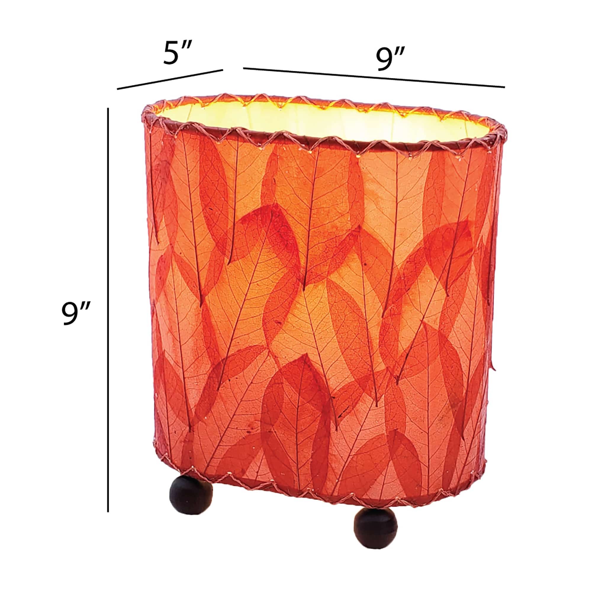 Crafted by the artisans of Eangee Home Design, the Mini Guyabano Table Lamp in red against a clean backdrop, featuring fossilized cocoa leaf shade, guyabano leaf shade, wrought iron frame.