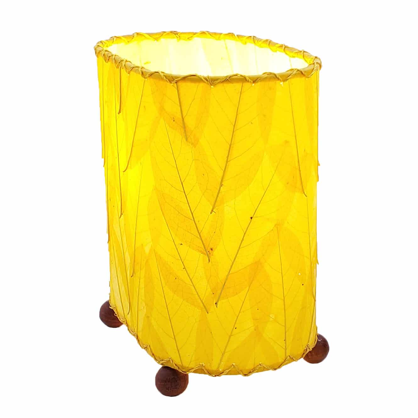 Crafted by the artisans of Eangee Home Design, the Mini Guyabano Table Lamp in yellow against a clean backdrop, featuring fossilized cocoa leaf shade, guyabano leaf shade, wrought iron frame.