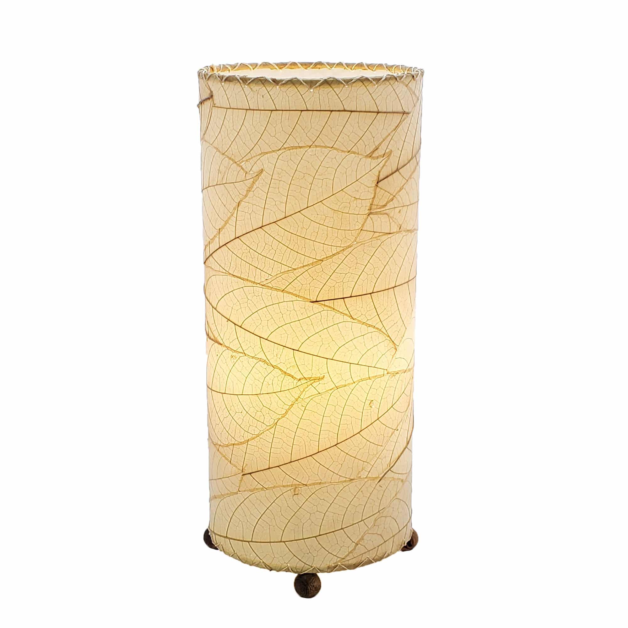 Crafted by the artisans of Eangee Home Design, the Cocoa Leaf Cylinder Table Lamp in natural against a clean backdrop, featuring fossilized cocoa leaf shade, wrought iron frame, handcrafted.