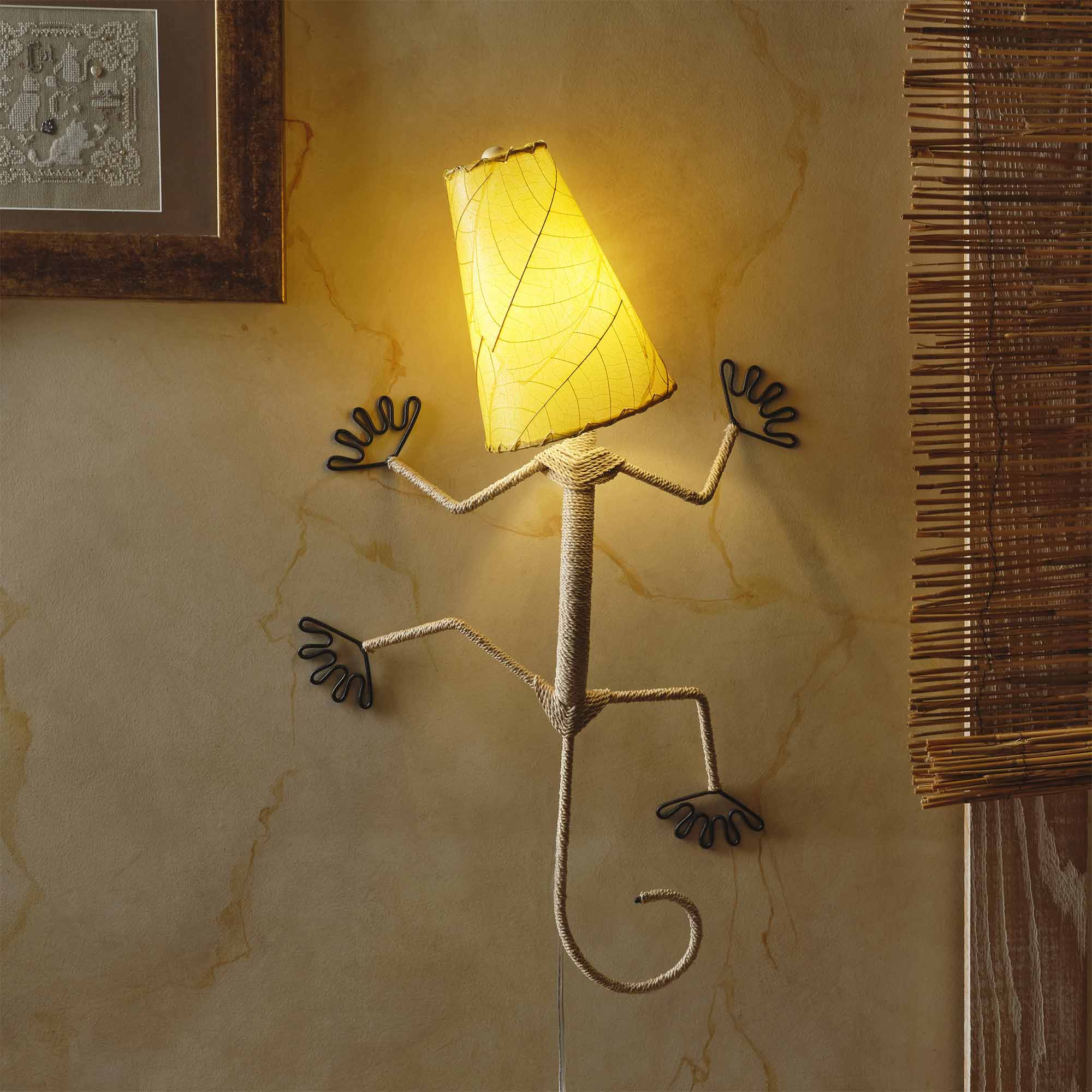 Crafted by the artisans of Eangee Home Design, the Gecko Wall Lamp Combo in yellow against a clean backdrop, featuring fossilized cocoa leaf shade, abaca rope accents, wrought iron frame, handcrafted.