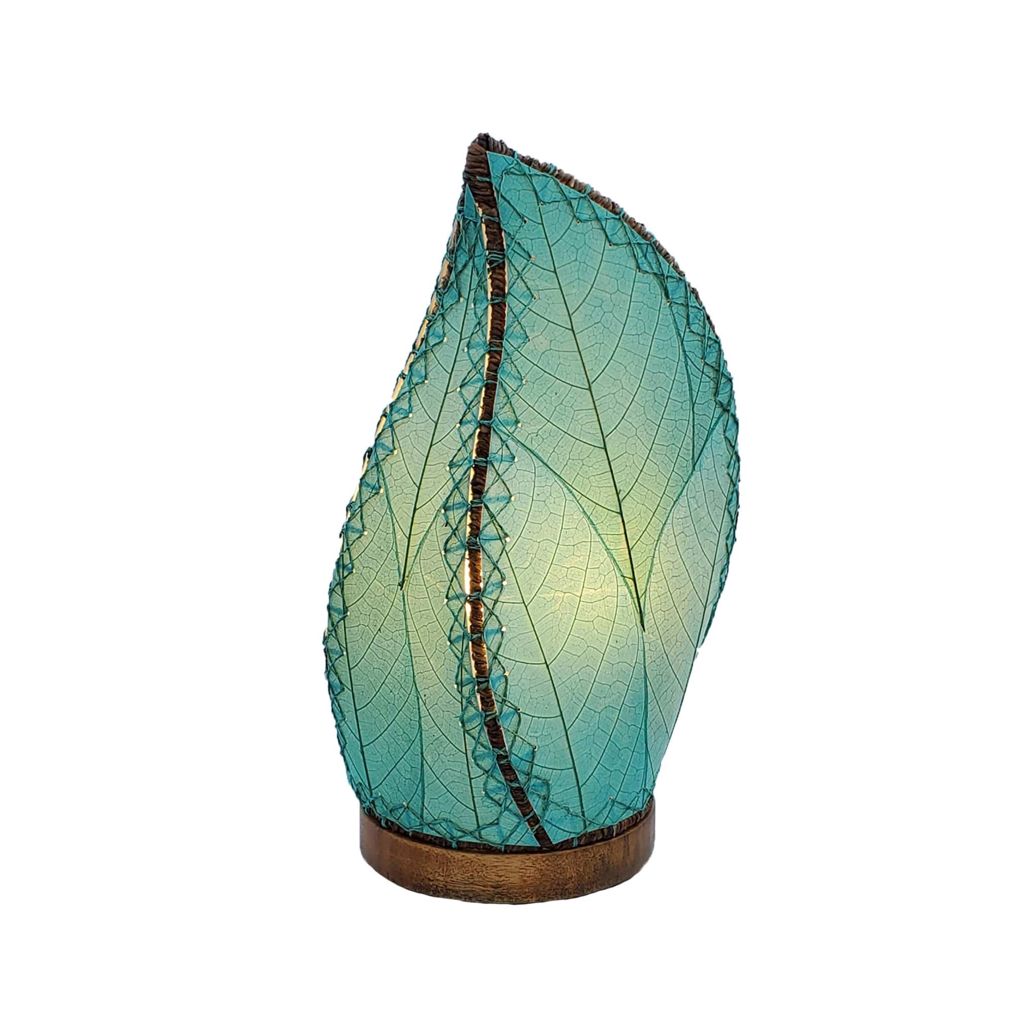 Crafted by the artisans of Eangee Home Design, the Leaflet Table Lamp in sea blue against a clean backdrop, featuring fossilized cocoa leaf shade, abaca rope accents, reclaimed mango wood base, wrought iron frame, sustainably sourced.