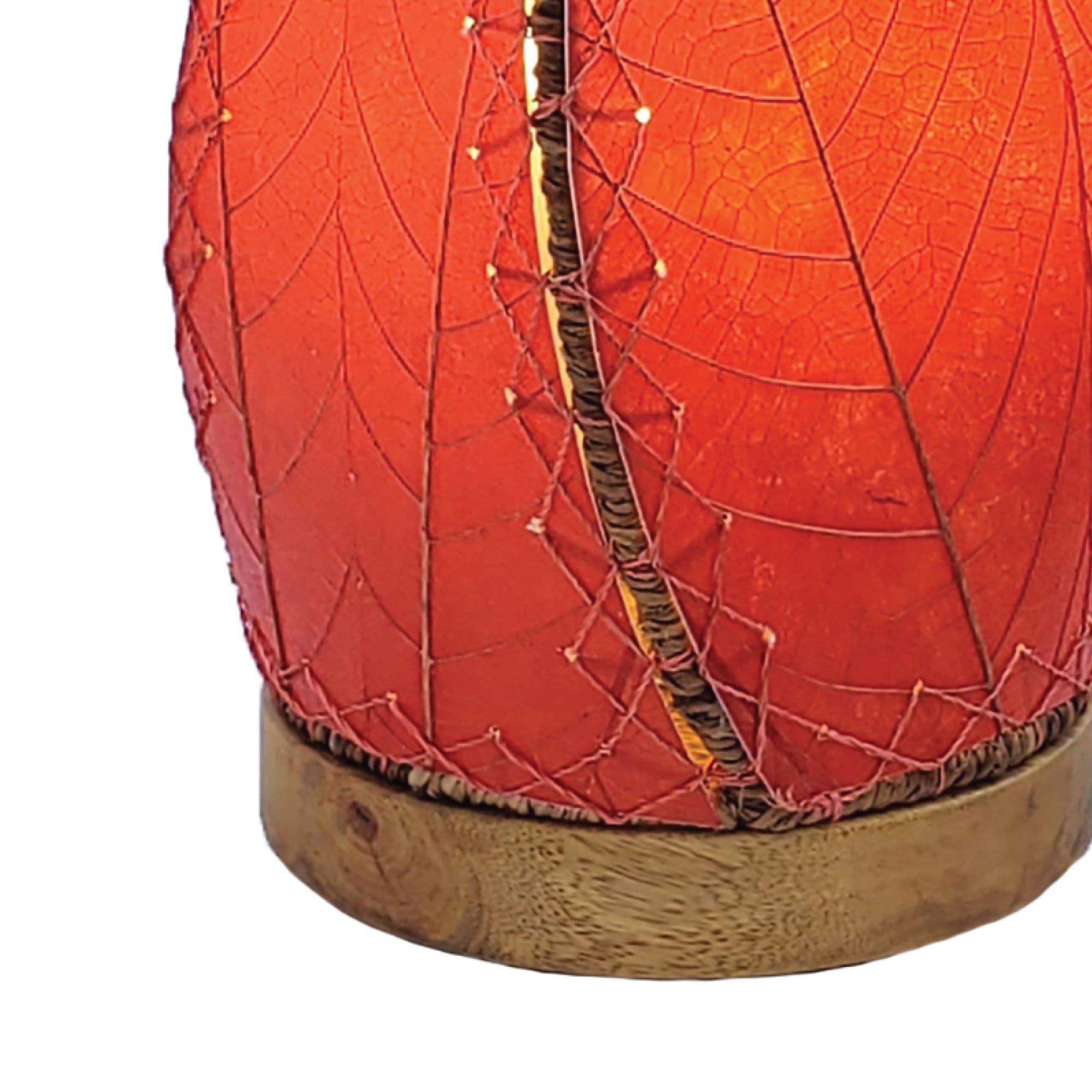Crafted by the artisans of Eangee Home Design, the Leaflet Table Lamp in red against a clean backdrop, featuring fossilized cocoa leaf shade, abaca rope accents, reclaimed mango wood base, wrought iron frame, sustainably sourced.