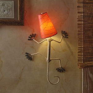 In a sun drenched entryway, crafted by the artisans of Eangee Home Design, the Gecko Wall Lamp Shade in red hangs, featuring fossilized cocoa leaf shade, abaca rope accents, wrought iron frame, handcrafted, adding warmth and character to the space.